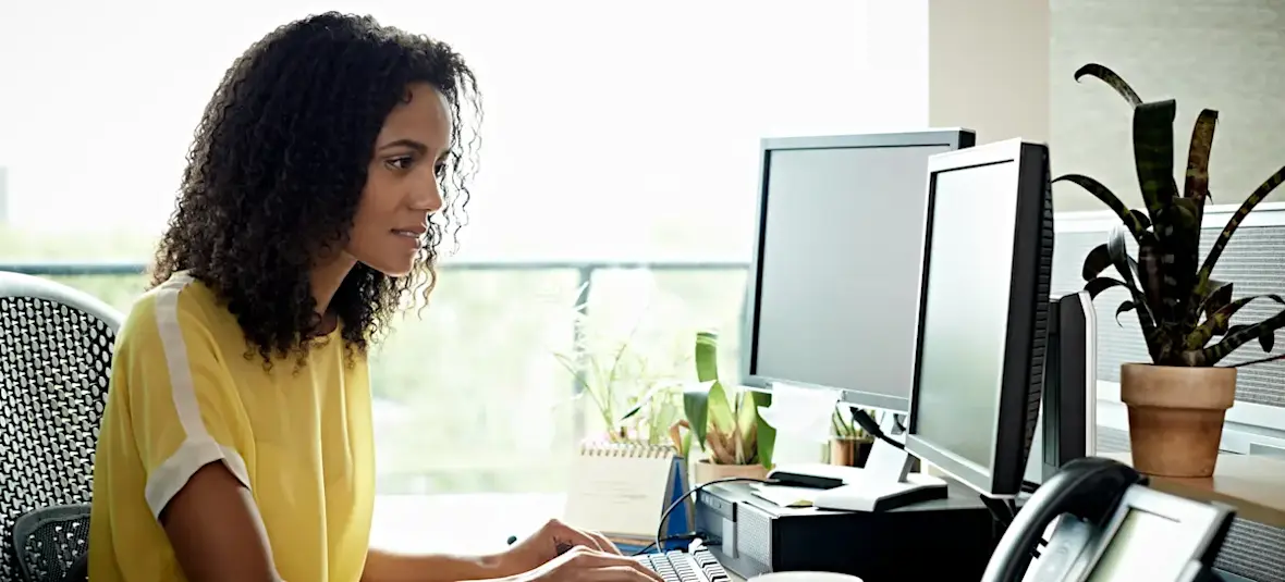 [Featured Image] An employee composes a resignation letter for an employer.