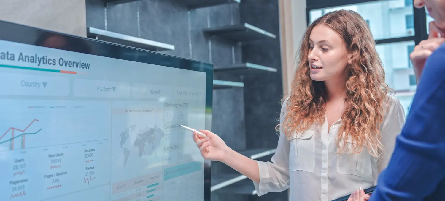 [Featured Image] A project coordinator assigns tasks, creates a report, and discusses aspects of a project with a project manager.
