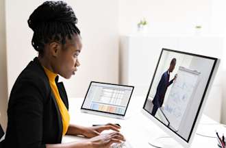 [Featured image] A sales rep with a Salesforce certification works on a desktop computer. 