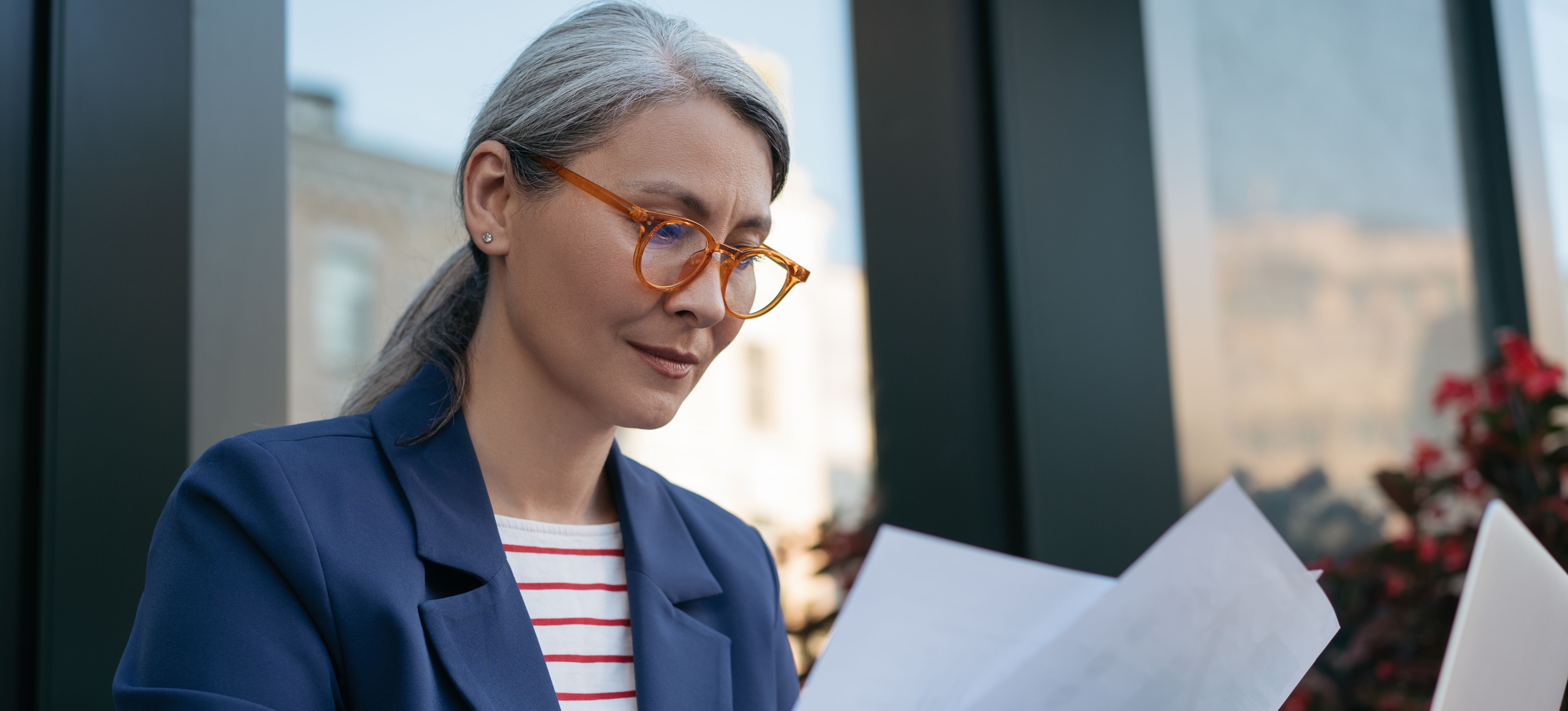 [Featured Image] A professional in business casual clothing reviews resumes.