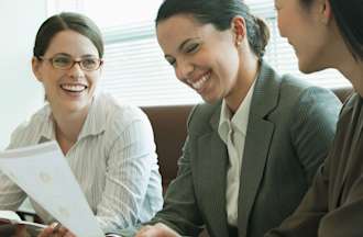 [Featured image] A director of growth meets with two colleagues to discuss new growth strategies. 