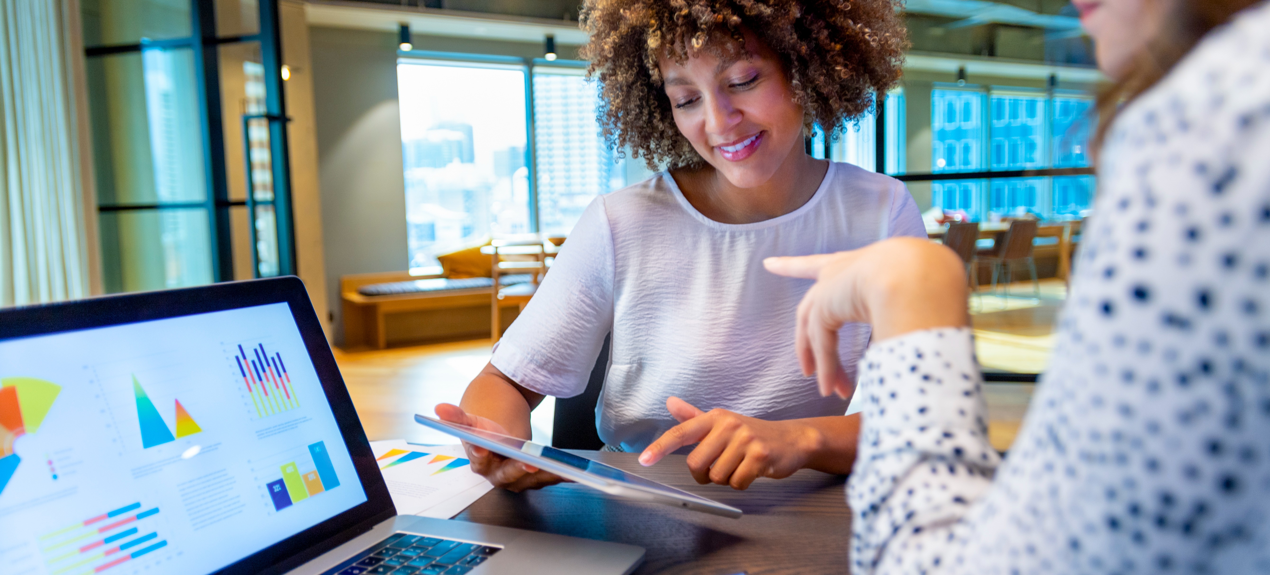 [Image en vedette] Deux spécialistes du marketing sont assis dans leur bureau devant un ordinateur portable et regardent des exemples d'analyses prédictives pour déterminer quels clients doivent être ciblés.