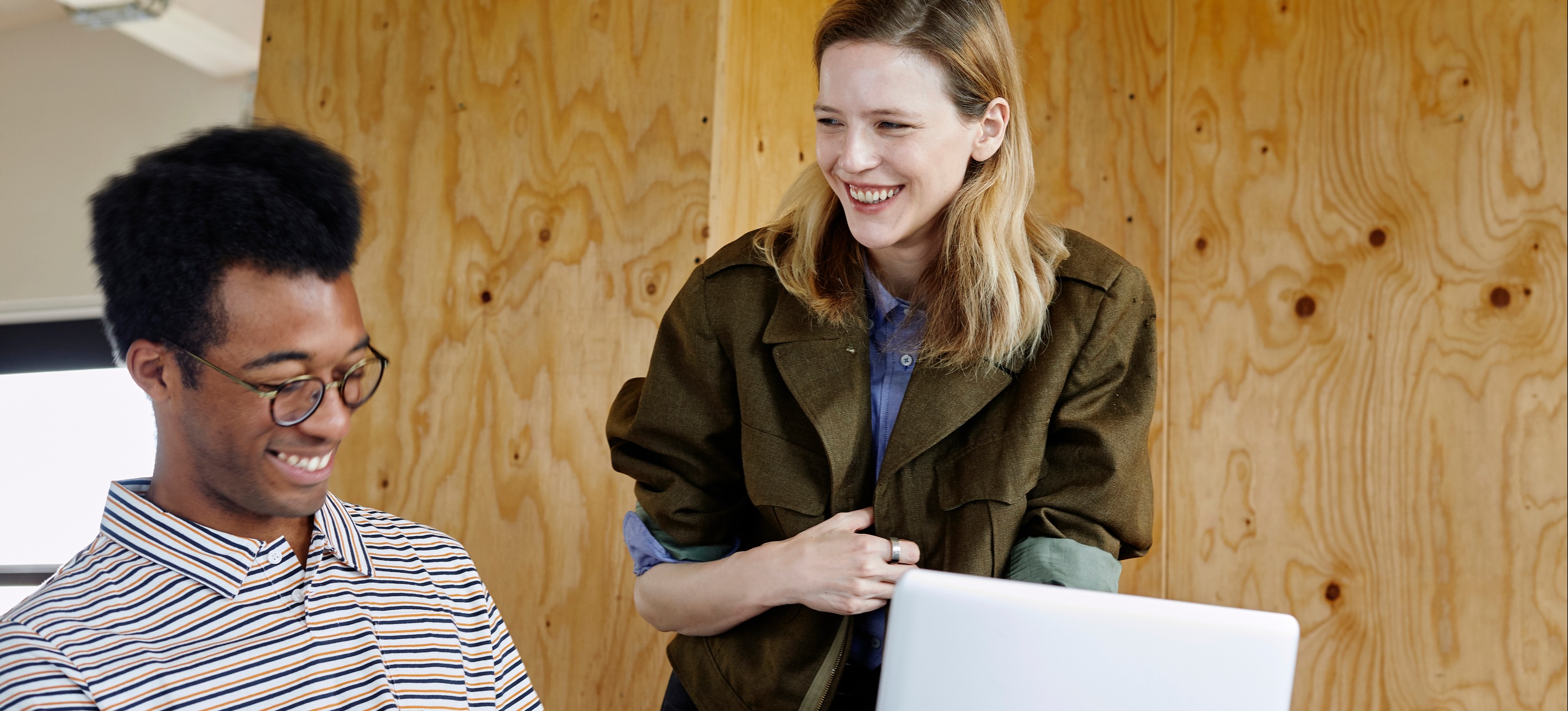 [Featured image]: Smiling workers discussing usability.
