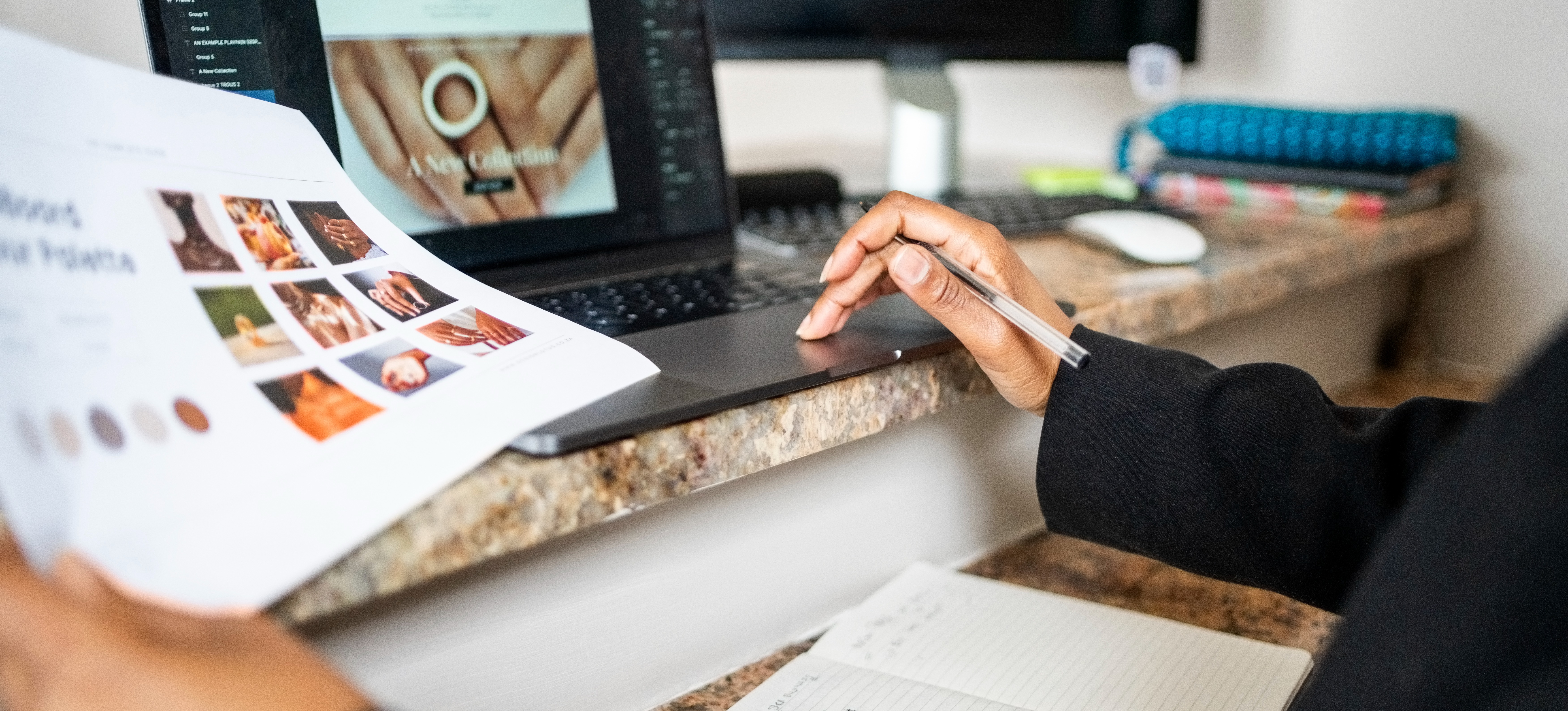 [Featured Image] The hands of a front-end engineer work on a laptop computer and hold a paper full of inspiration for designing a client's website.