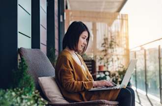 [Featured image] An IT support specialist is on a balcony using their laptop to learn about IPv6.