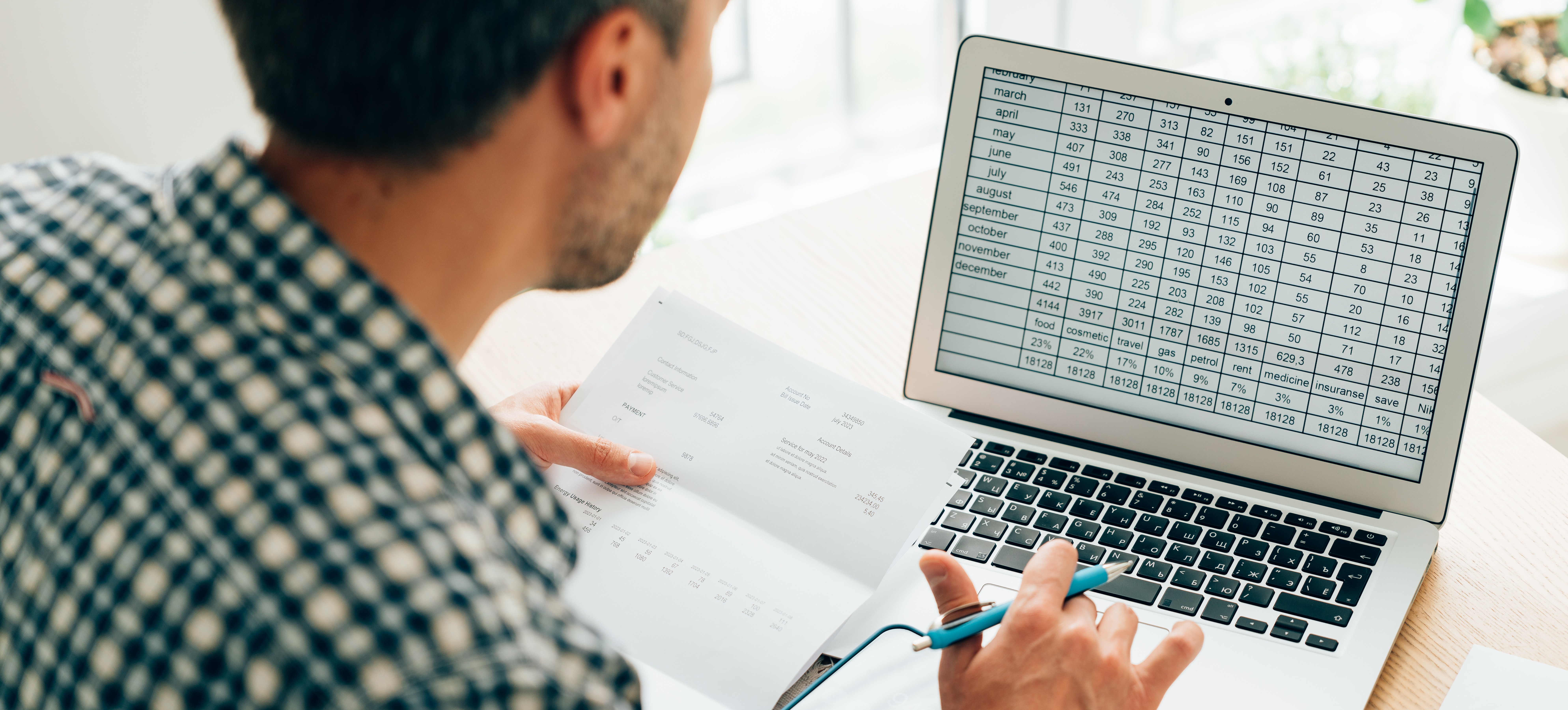 [Featured Image]: A person looks through a spreadsheet on a device to locate data for econometric modeling.
