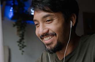 [Featured image] A tech worker listens to a cybersecurity podcast as he works.