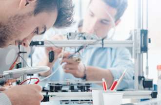 [Featured Image] Group of engineering students getting hands-on knowledge about what electrical engineers do while building relevant skills in an engineering lab.
