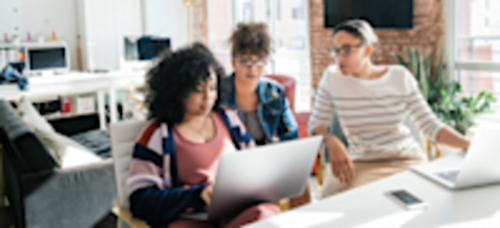 [Featured image] Three software engineers collaborate on a project at the office.