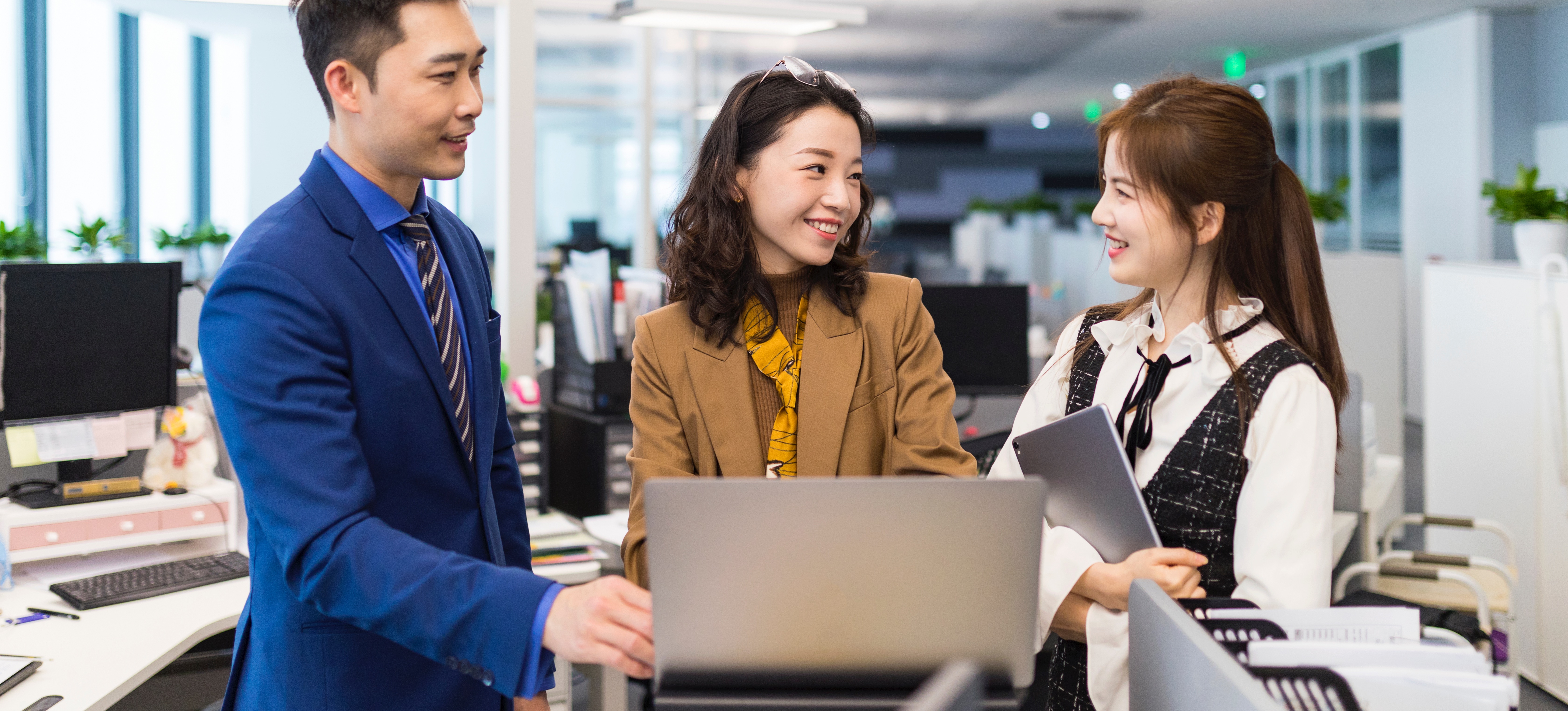 [Featured Image] A team of professionals in a work environment interacting and discussing HRIS certification.
