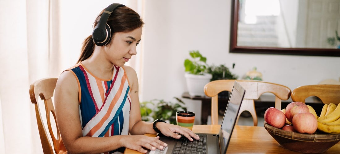 [Featured image] Person wearing headphones adds custom error bars on Google Sheets on their laptop.