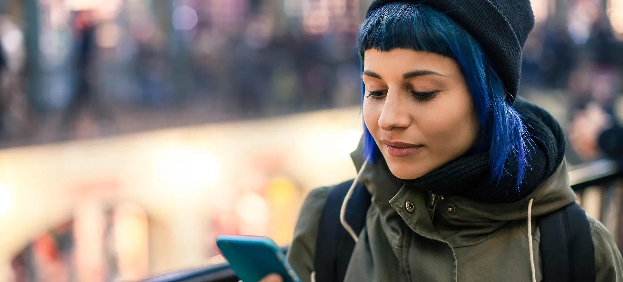 [Featured Image] A person walks outside while looking at their phone and reading about data security issues in the US. 