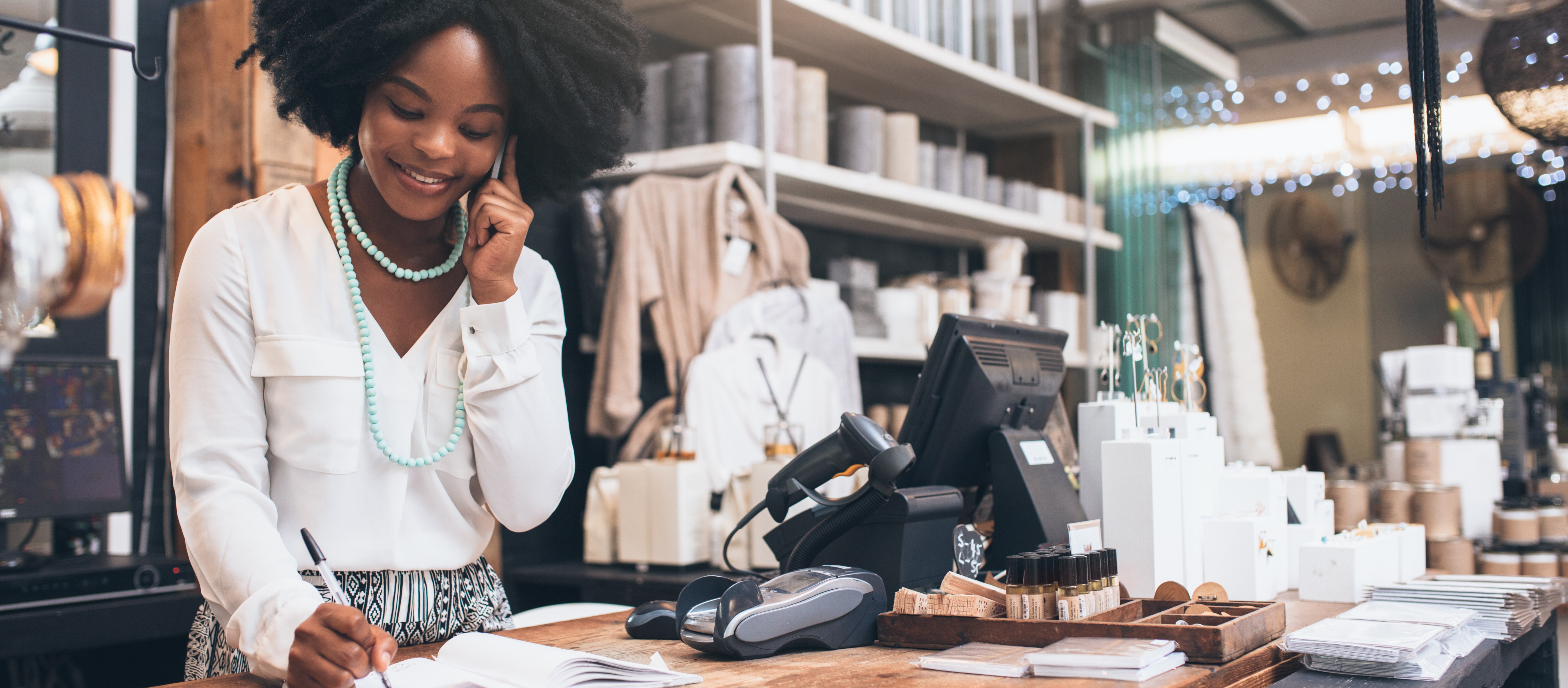 [Featured Image] A business owner works in their shop after earning their degree. 