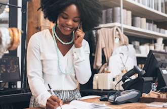 [Featured Image] A business owner works in her shop after earning her degree. 