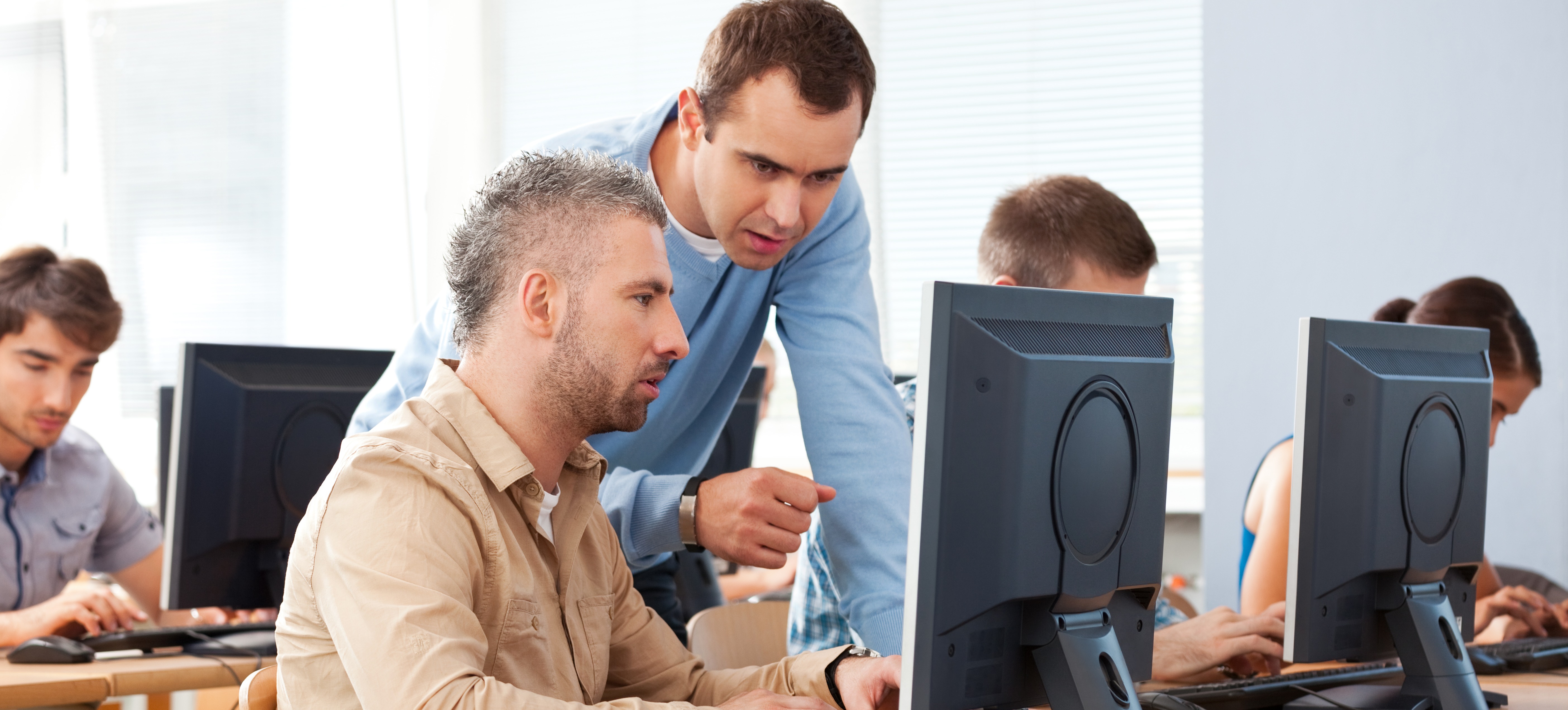 [Featured Image] Aspiring computer network architects learn about CSMA and its importance in data collision avoidance in a classroom setting.
