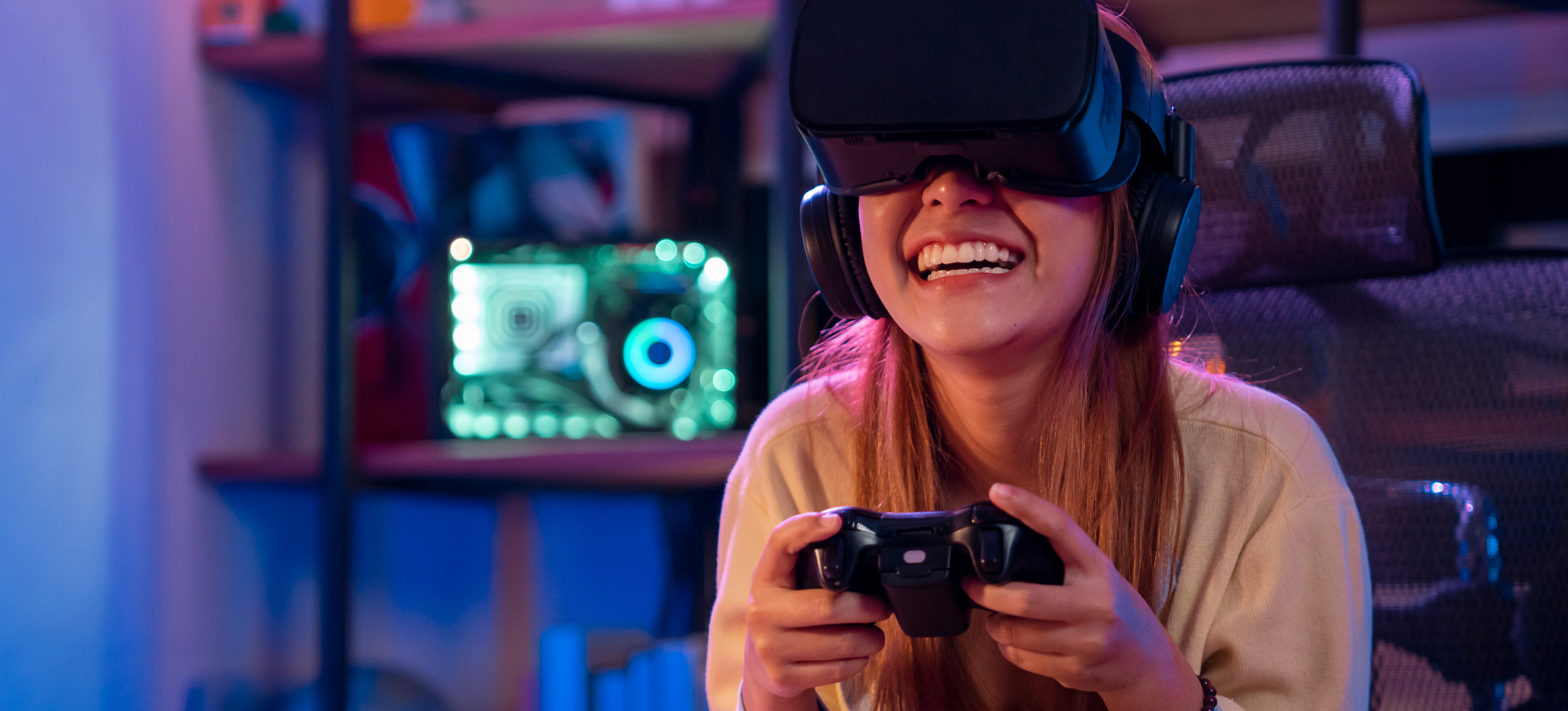 [Featured Image] A smiling person is using virtual reality to enhance their video game experience.

