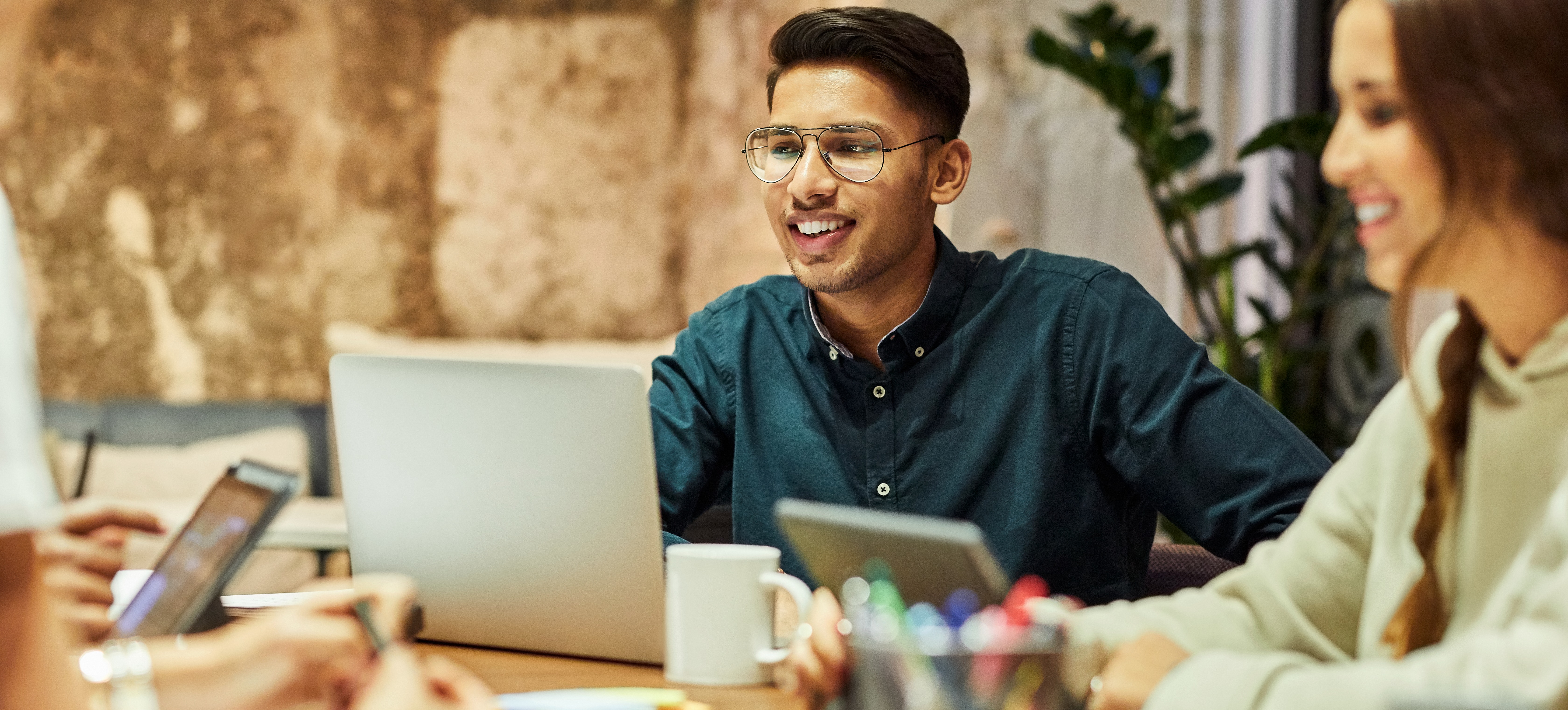 [Featured Image] Colleagues discuss the results from their latest round of user acceptance testing (UAT).
