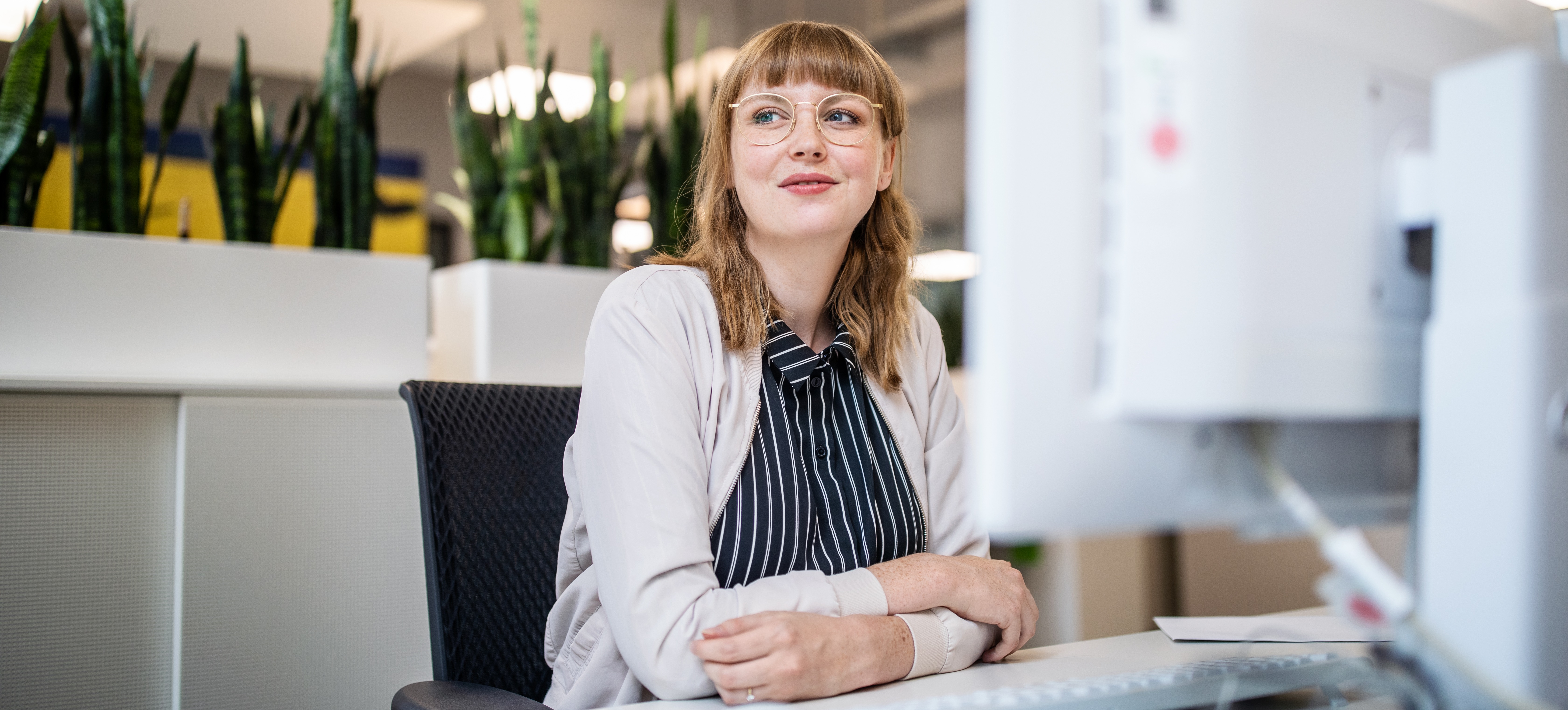 [Image en vedette] Un homme d'affaires satisfait sourit dans son bureau après avoir reçu une évaluation positive dans le cadre du processus de gestion des performances sur son lieu de travail.