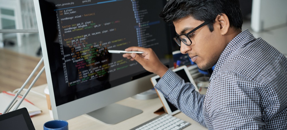 [Featured image] A machine learning engineer is looking at a program to ensure it practices machine learning fairness.