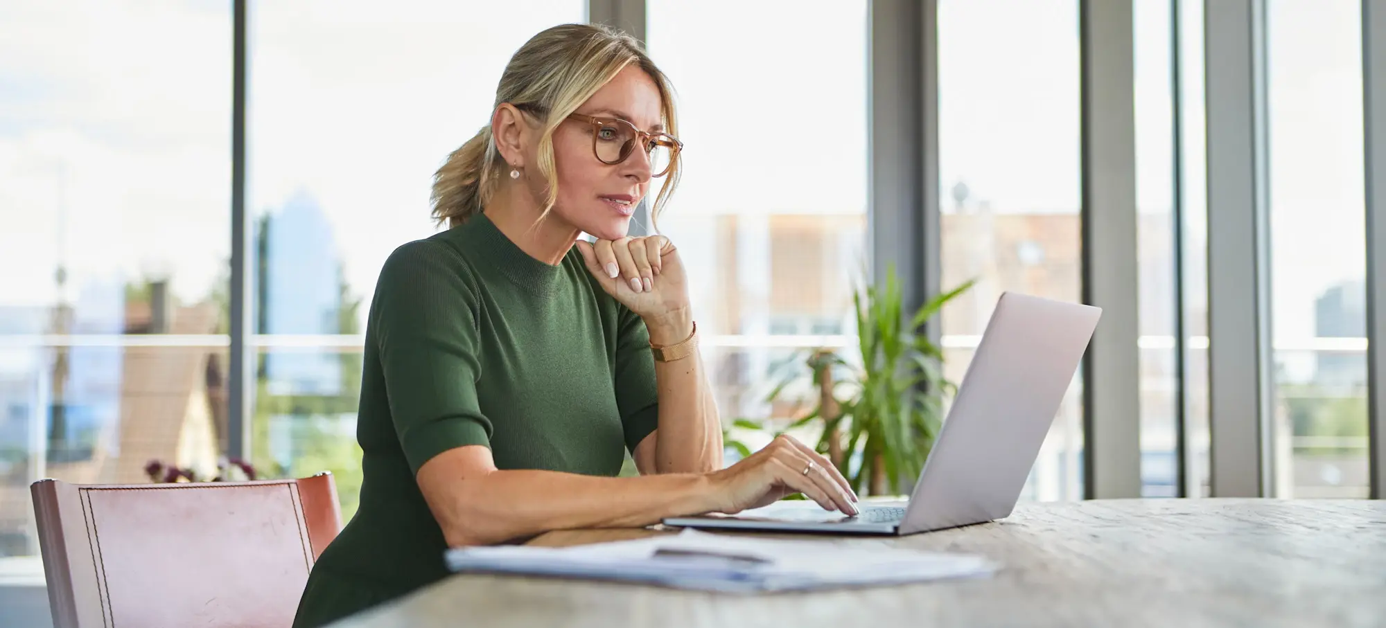[Featured Image] An adult student sits at a laptop in a library, taking an online machine learning course and learns about the LSTM neural network. 