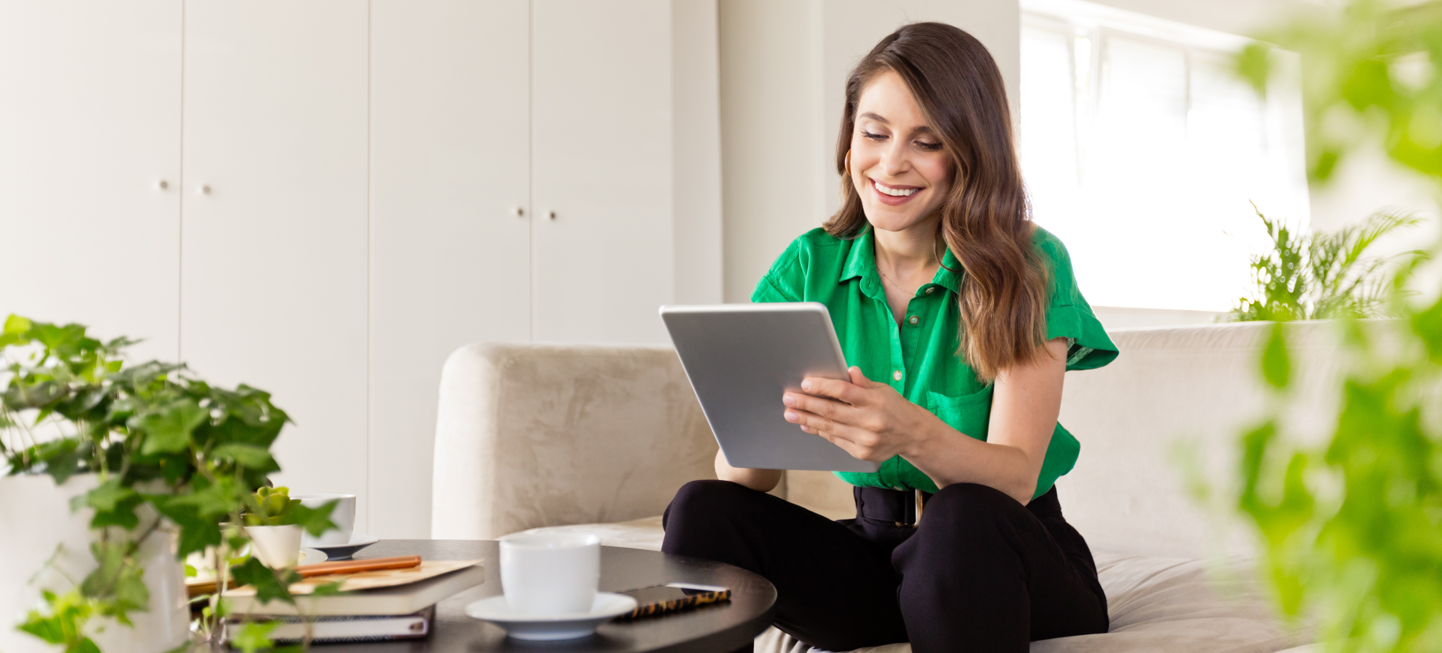 [Featured Image] A sustainability specialist works on a tablet to develop a new energy conservation program for their organization. 
