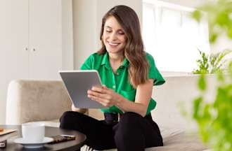 [Featured Image] A sustainability specialist works on a tablet to develop a new energy conservation program for her organization. 
