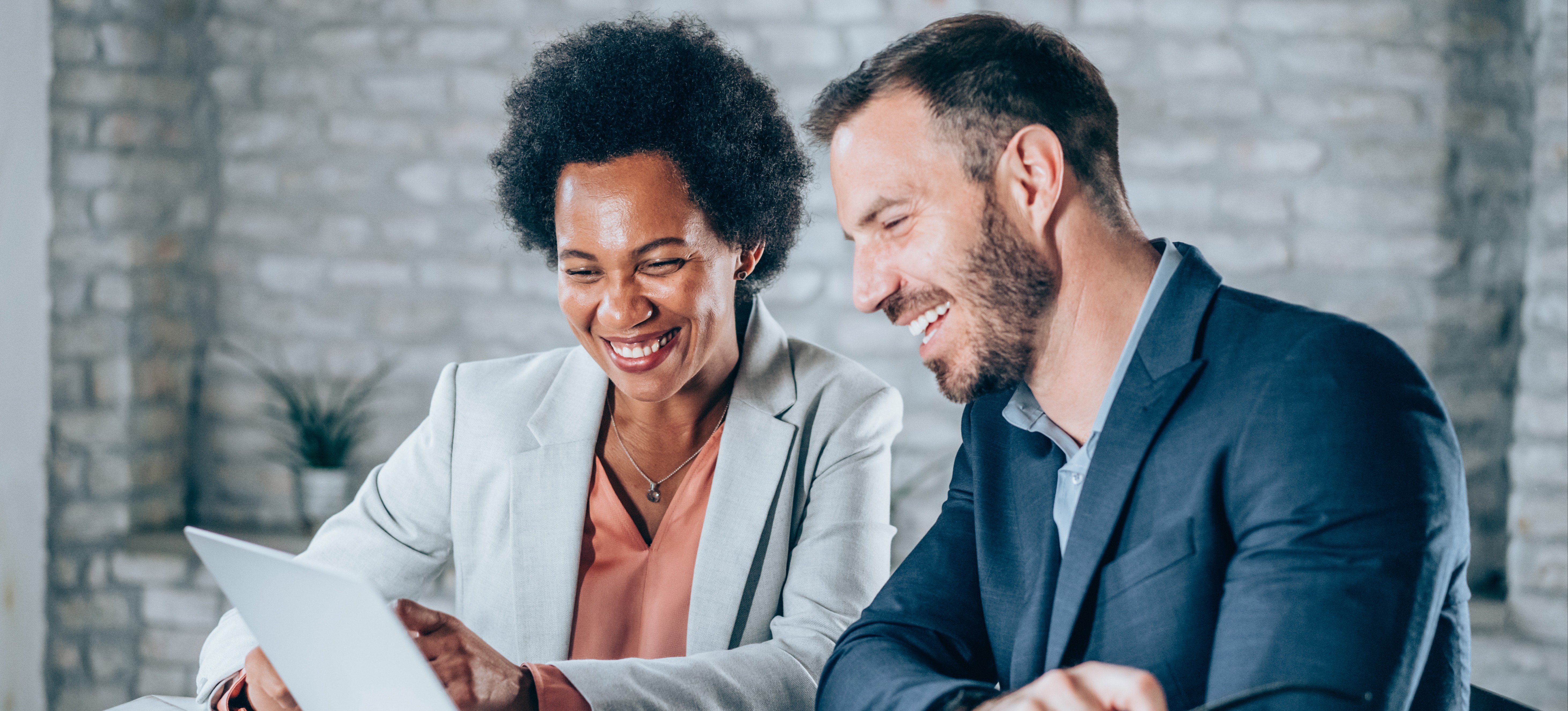 [Featured Image] Two salespeople discuss the importance of sales analytics and how to improve sales in the future.
