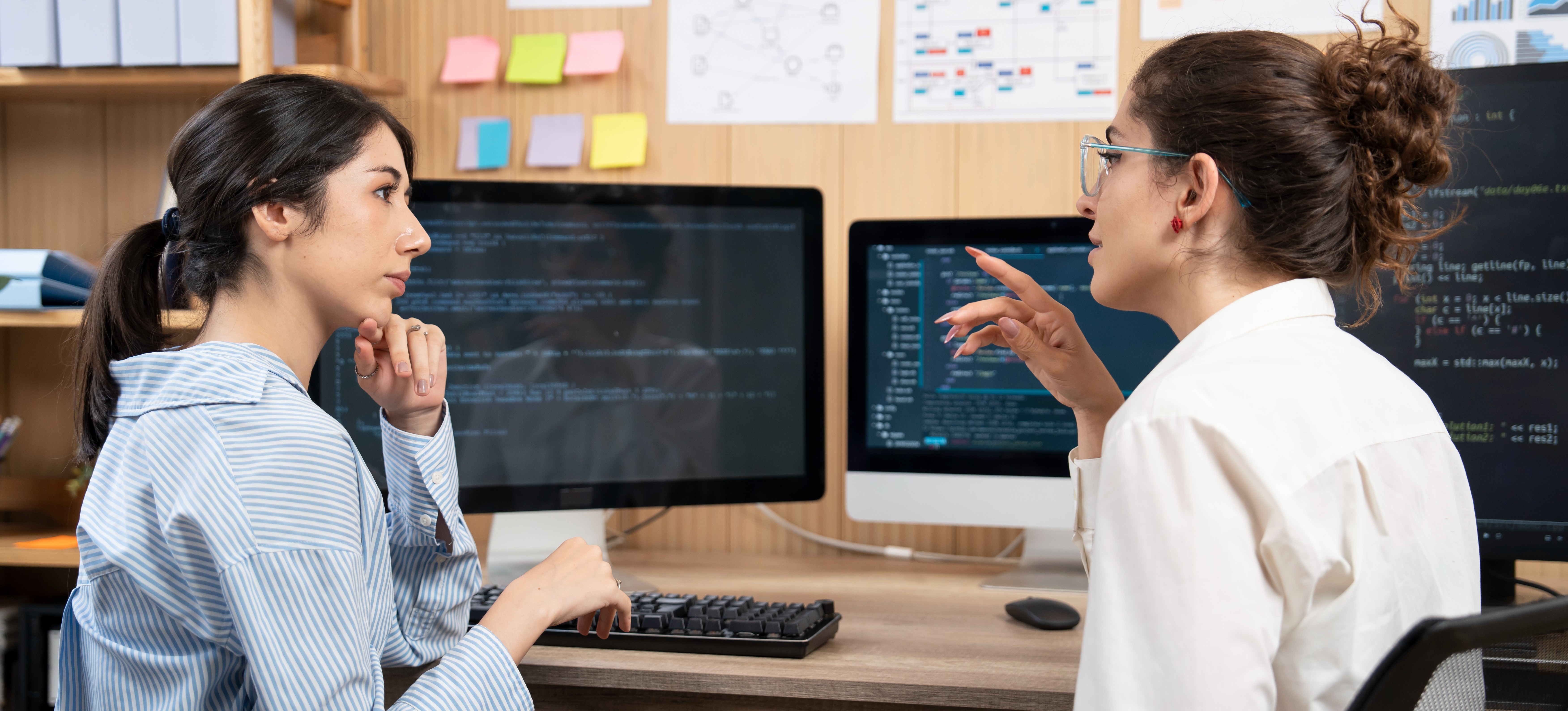 [Featured Image] Coworkers discuss the roles of data science vs. computer science in determining company processes and decisions.
