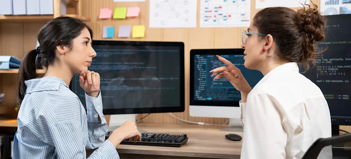 [Featured Image] Coworkers discuss the roles of data science vs. computer science in determining company processes and decisions.
