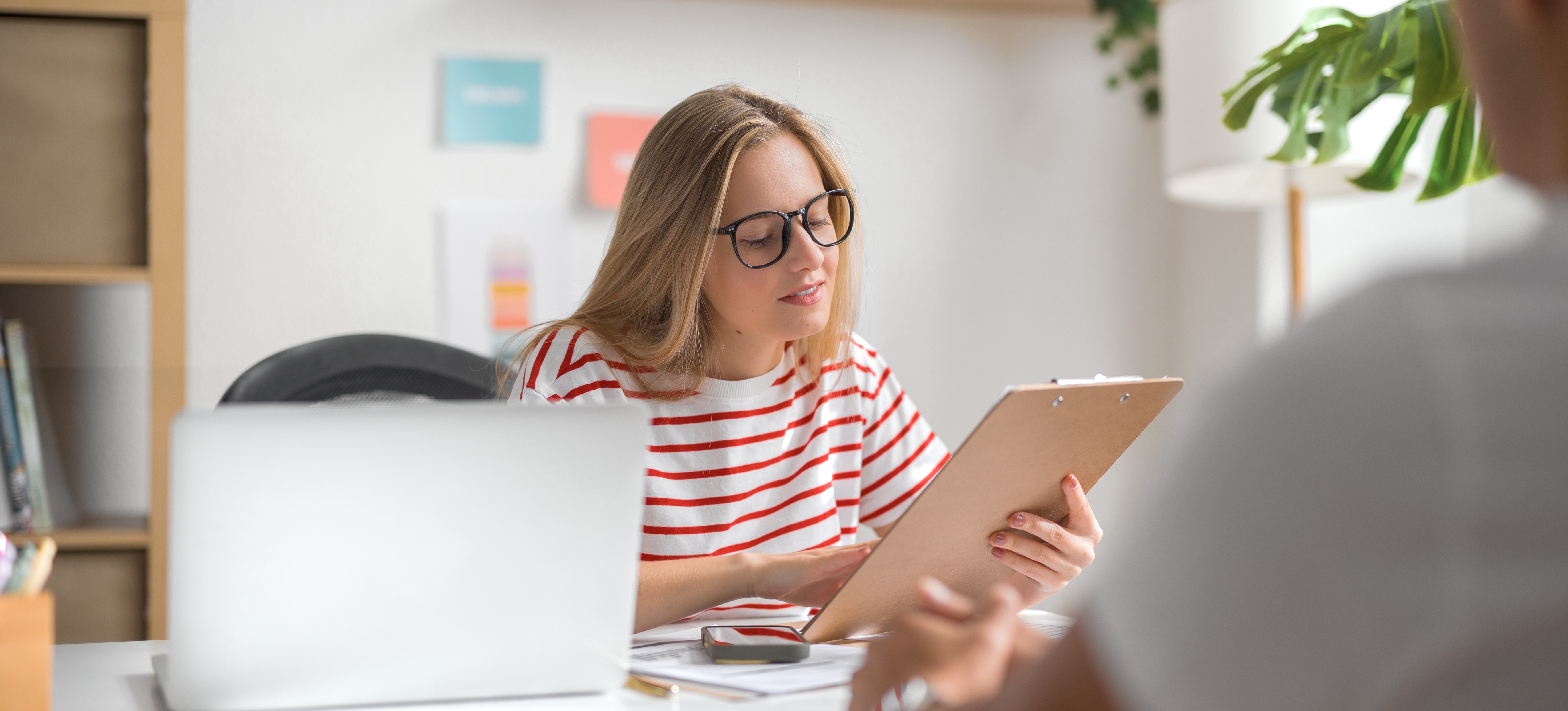 [Featured Image] A hiring manager reviews the data visualization resume of a candidate for an open position. 
