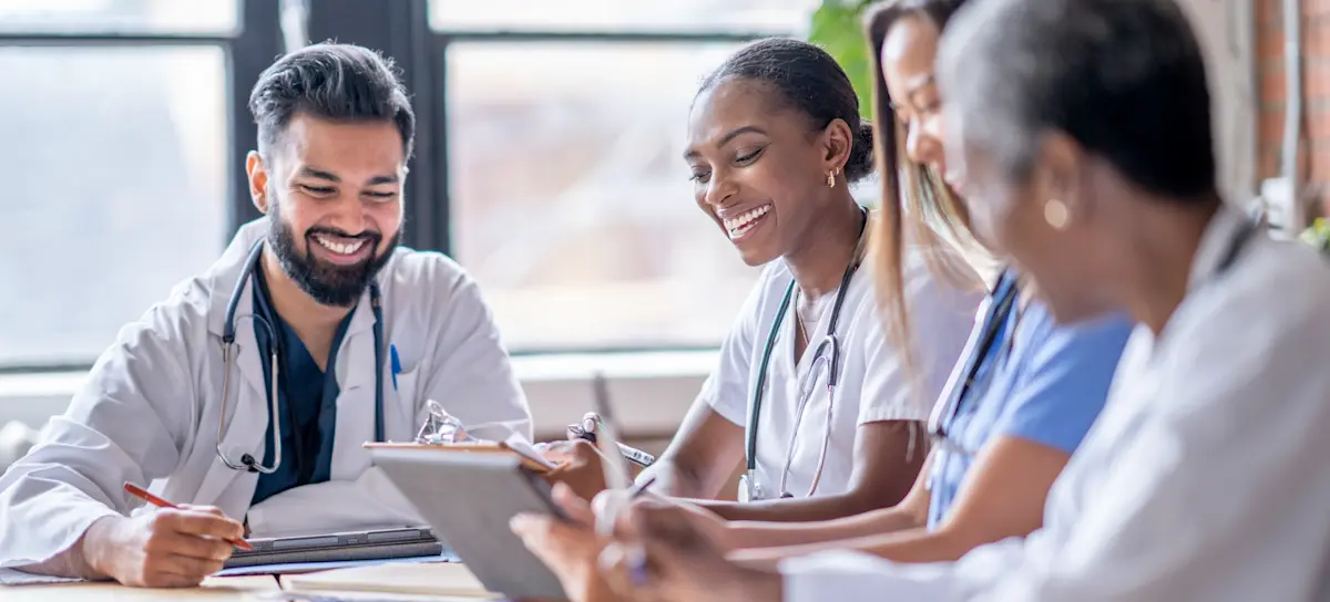 [Featured Image] Medical staff discussing the various aspects of health economics.
