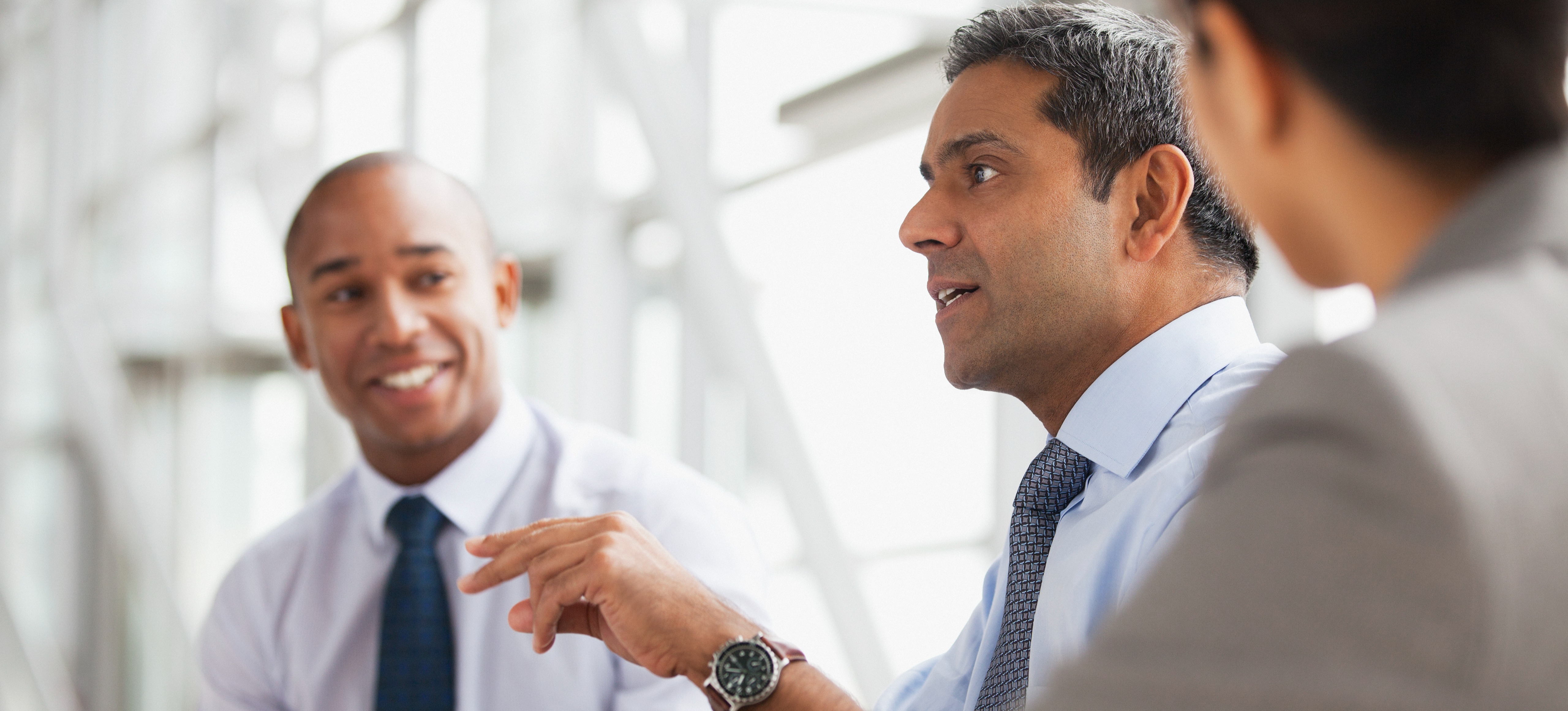 [Featured Image] A mentor coaches their mentees on improving their negotiation skills. 

