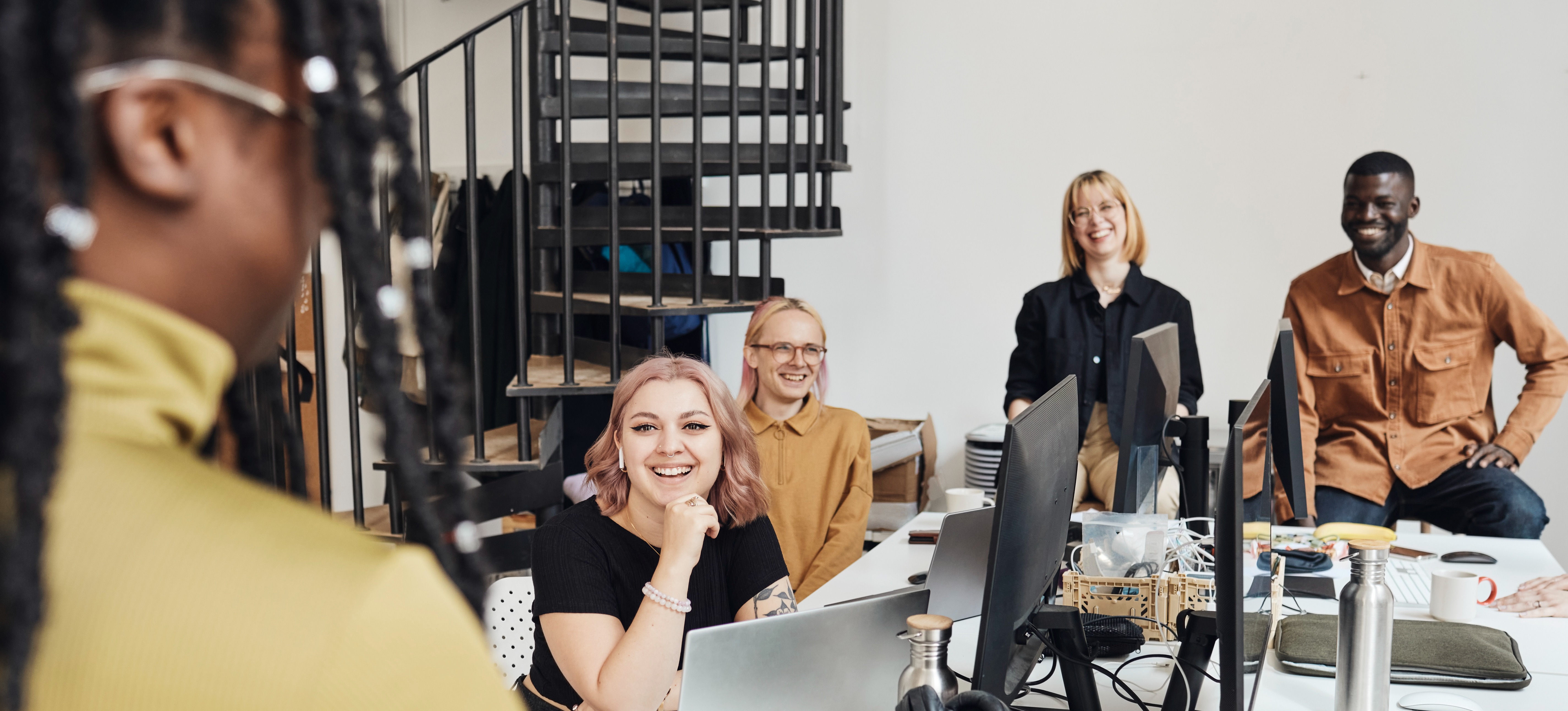 [Feature Image] A group of AI practitioners and cloud practitioners gathers in a meeting to discuss strategy for their next project. 
