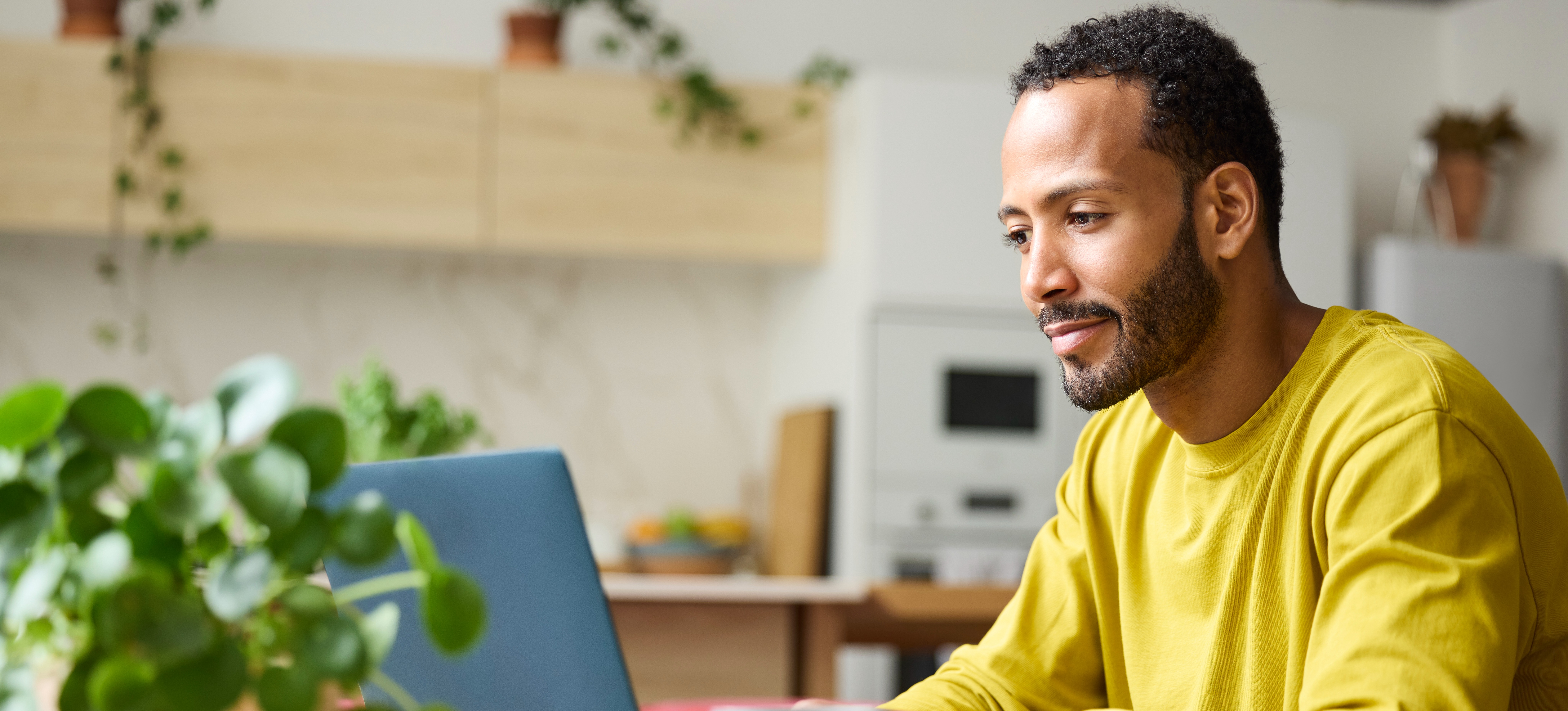 [Feature Image] A prospective robotics professional types a search into their laptop at home, asking, “Which programming language should I learn for robotics?”
