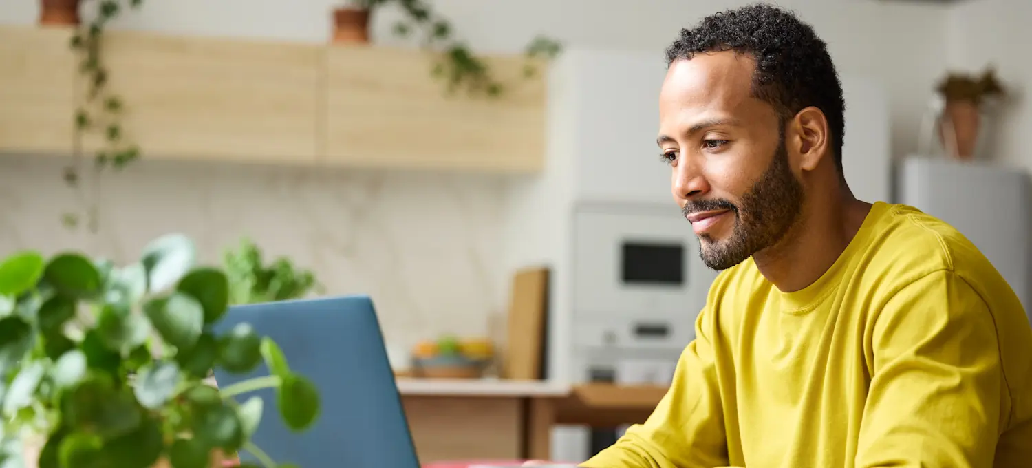 [Feature Image] A prospective robotics professional types a search into their laptop at home, asking, “Which programming language should I learn for robotics?”
