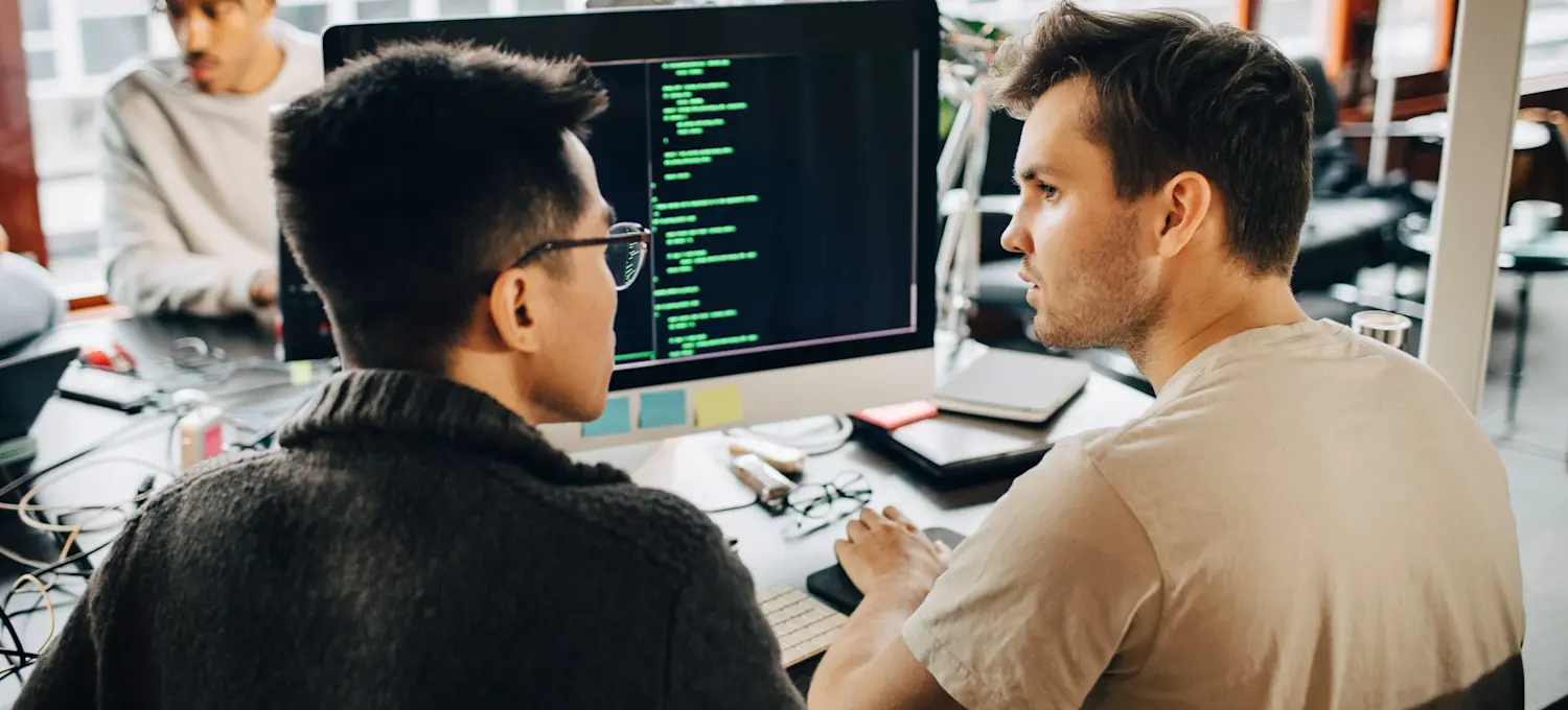 [Featured Image] Two programmers discuss the incredible capabilities of agentic rag while sitting in front of a computer in a shared office setting.
