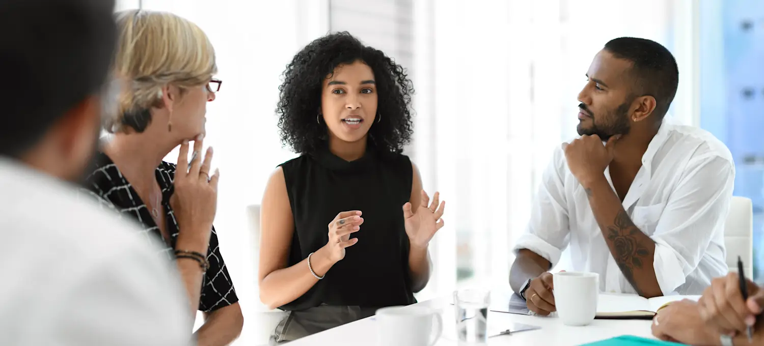 [Featured Image] A group of economists meet and discuss data they derived using time series analysis. 
