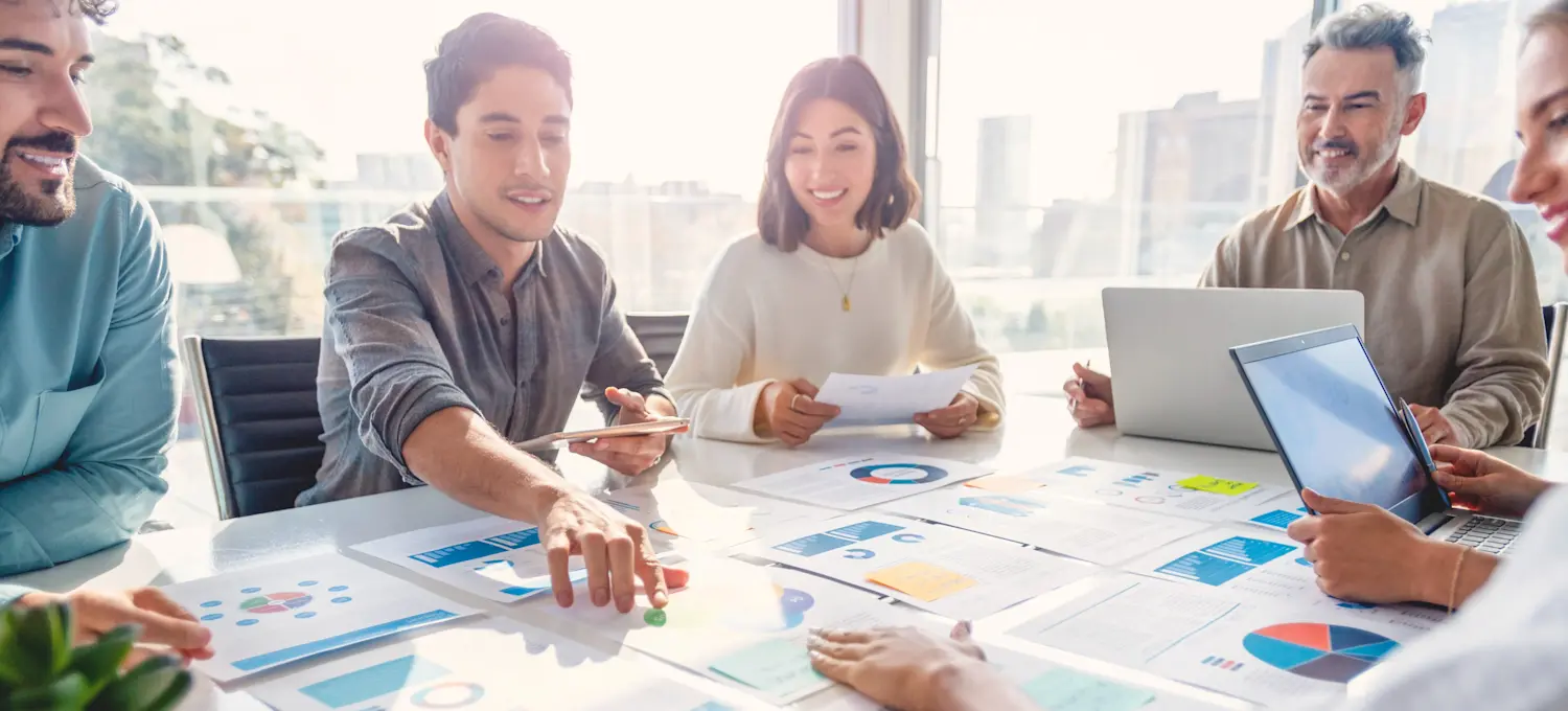 [Featured Image] A person working for a management analyst salary presents the data they have gathered to help the company lower costs and increase revenue. 
