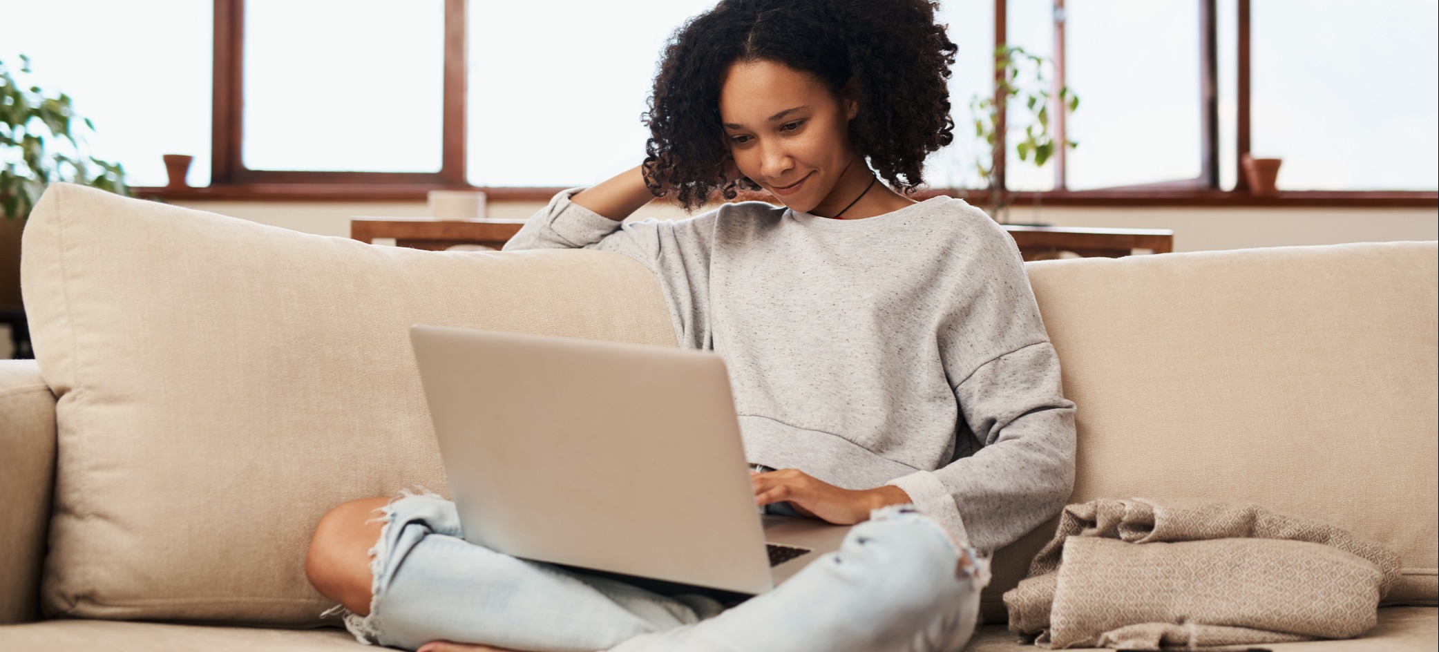 [Featured image] An entrepreneur works from home on their couch and uses Google Keyword Planner on their laptop.