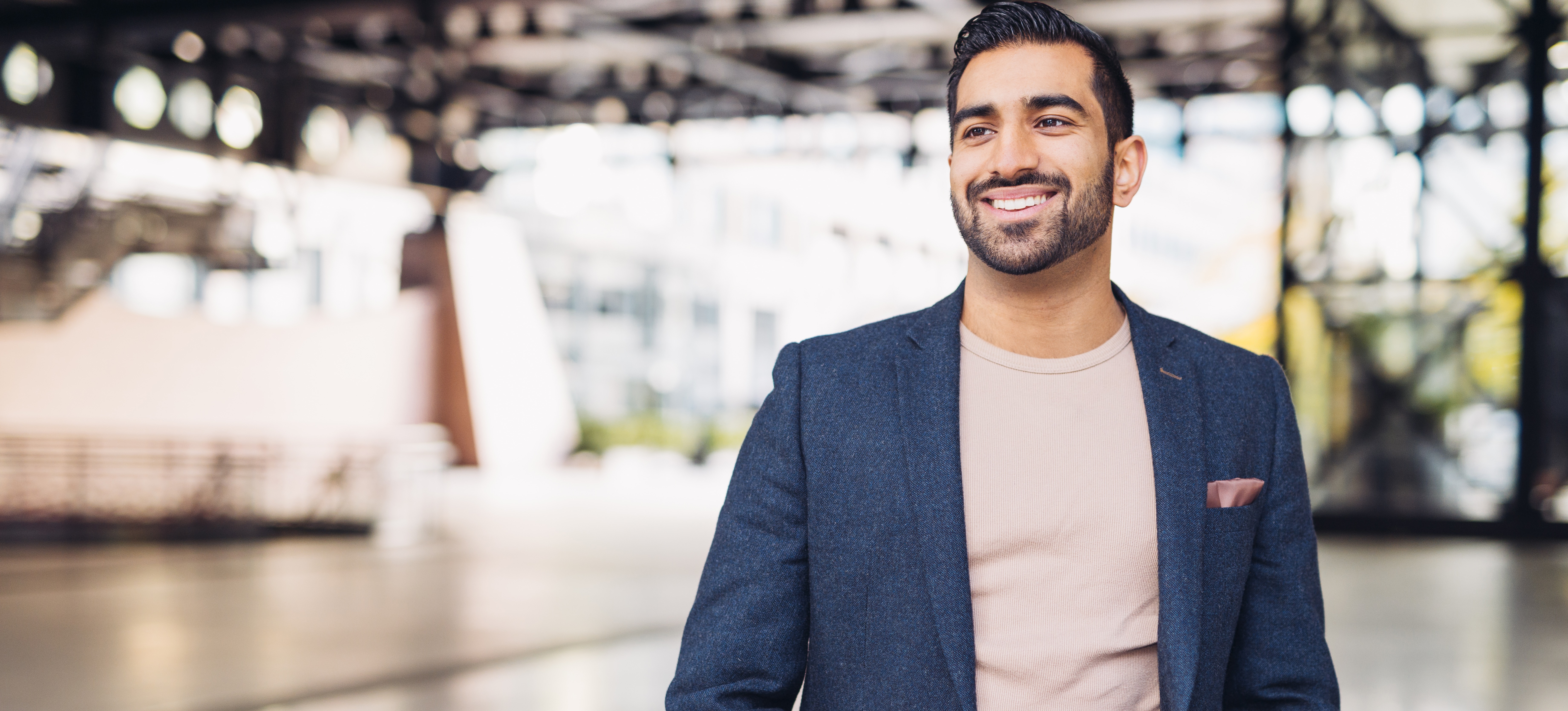 [Featured Image]: An entreprenuer smiles after brainstorming ideas to come up with a business name.
