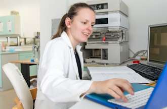 [Featured image] An applied scientist works on a computer in a lab. 