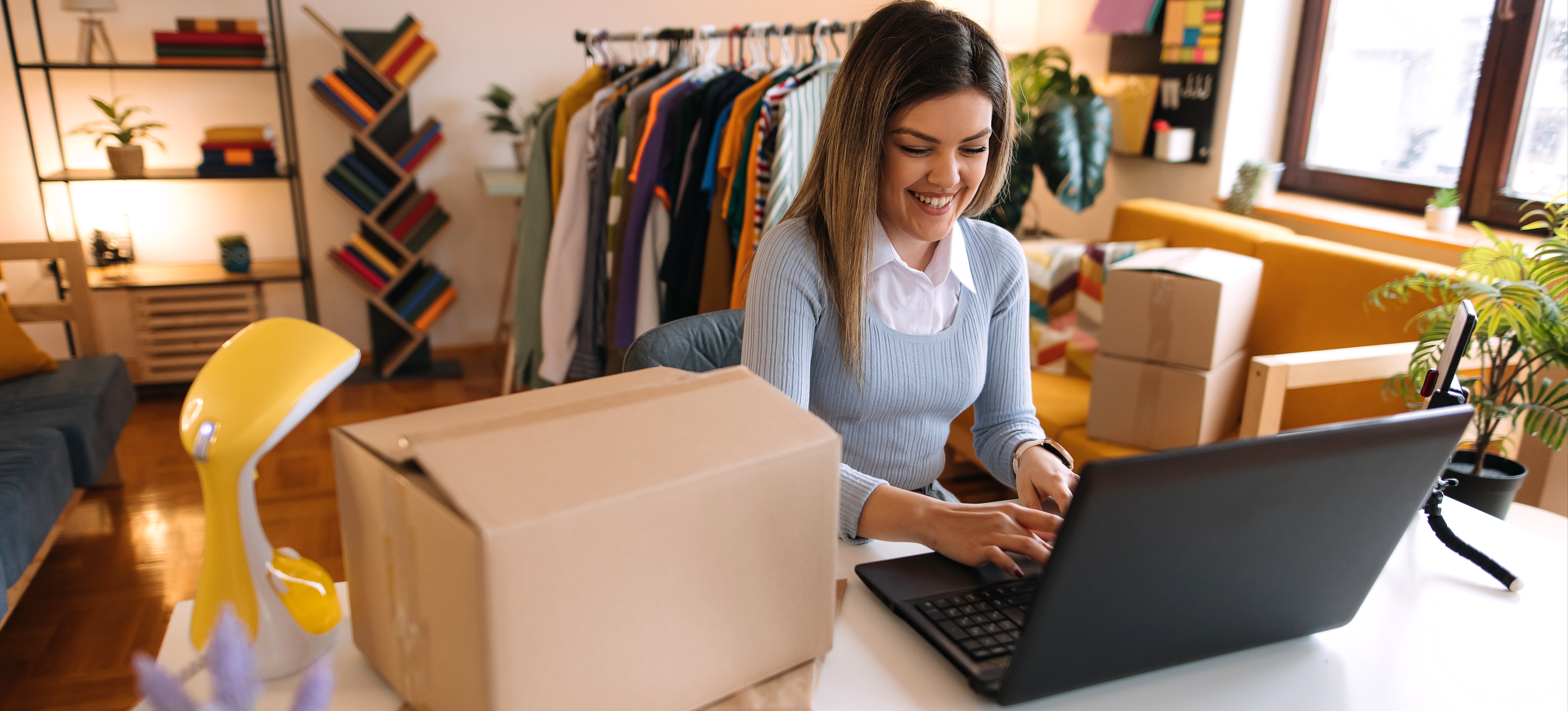 [Featured Image] A women selling products online, is on her laptop connecting her hubspot shopify integration.