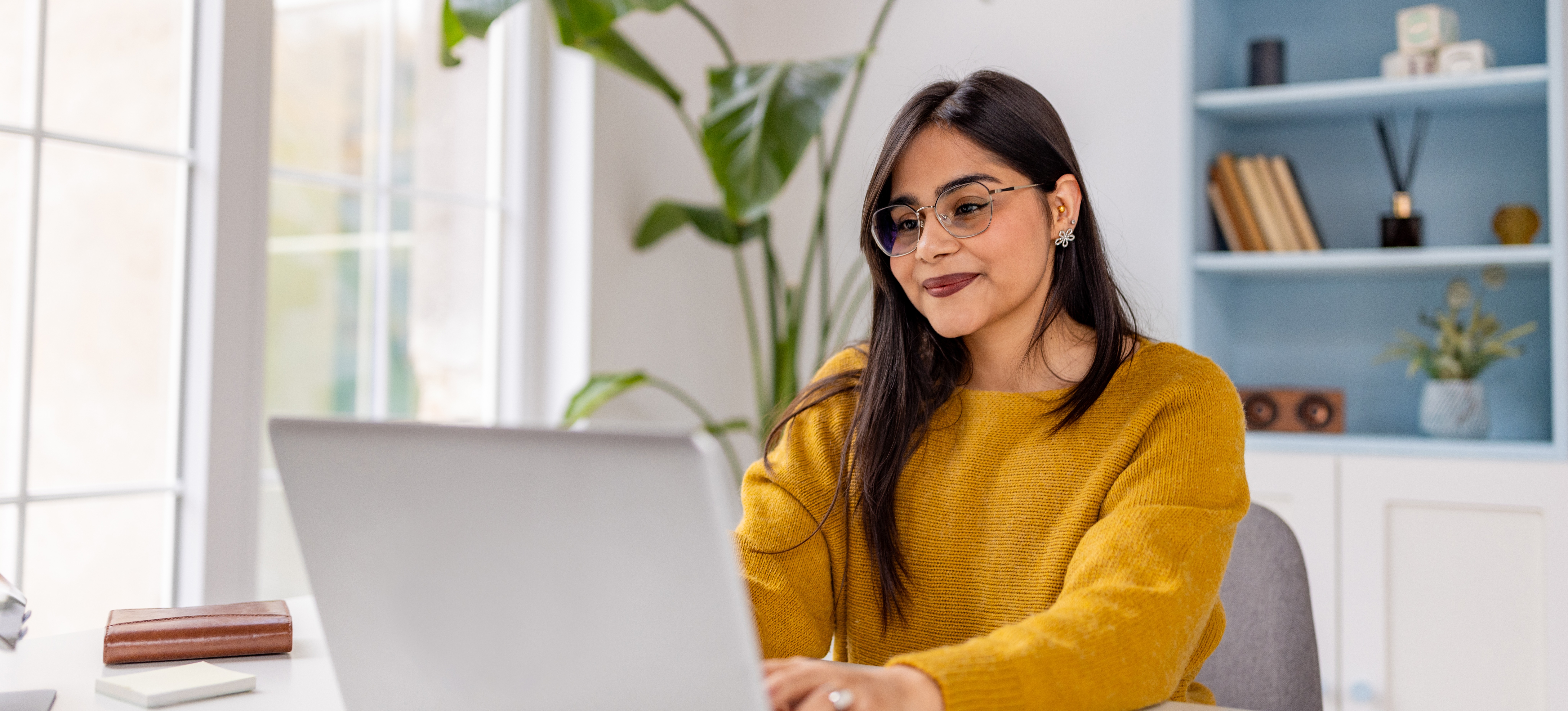 [Featured Image] A person in a home office studies for a professional certificate on a laptop.
