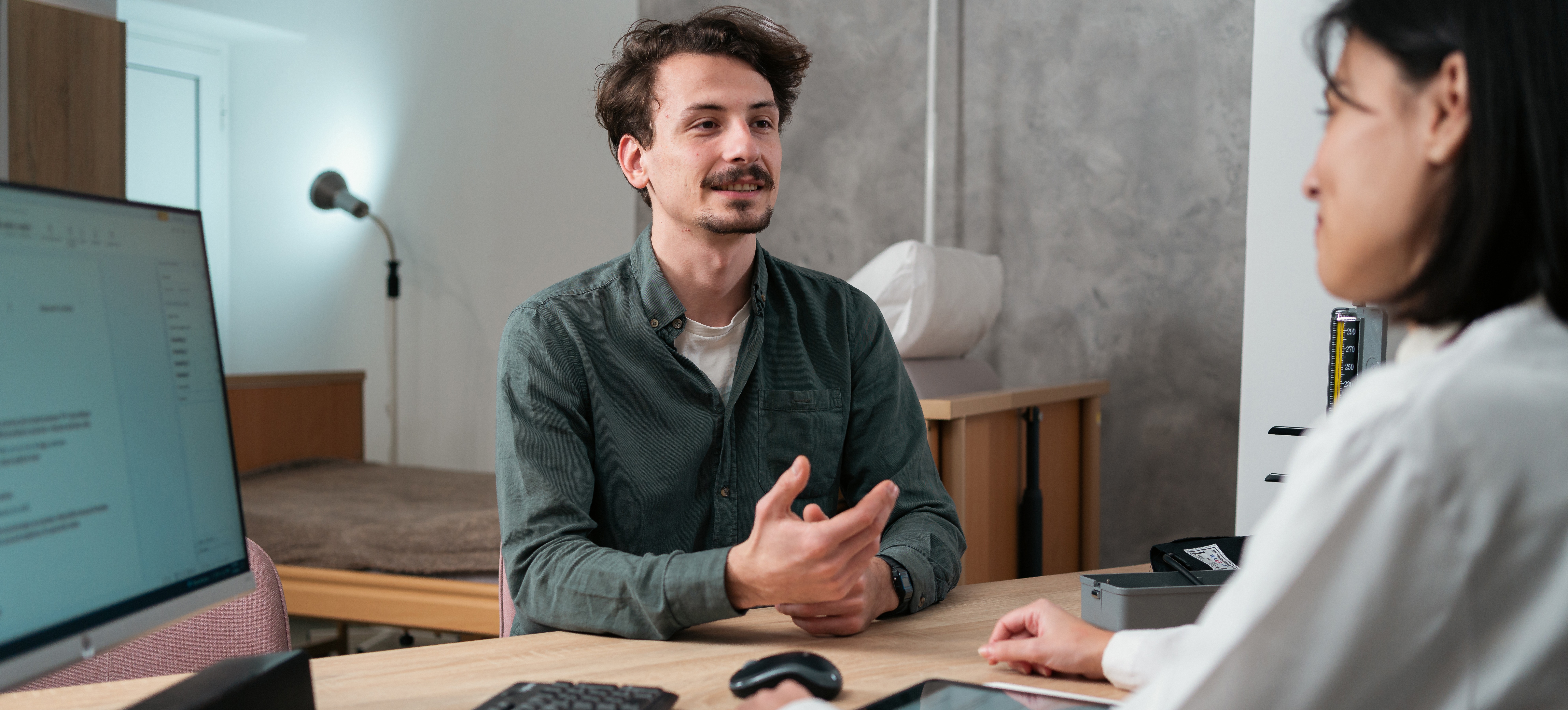 [Featured Image] A professional interview taking place in an office setting, with a recruiter and candidate discussing common natural language processing.