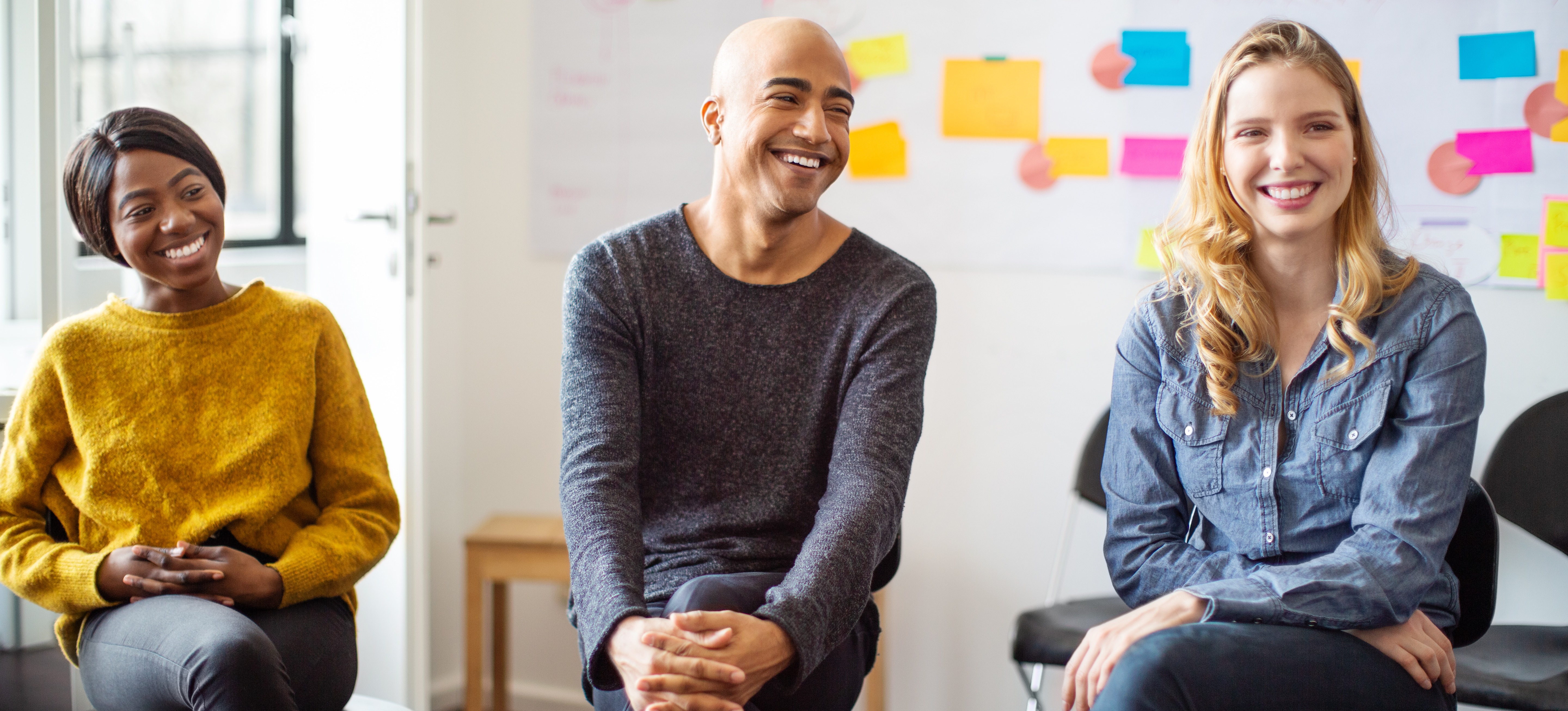 [Featured Image] Students and a teacher listening to another student present a talk about whether or not a marketing degree is worth it.

