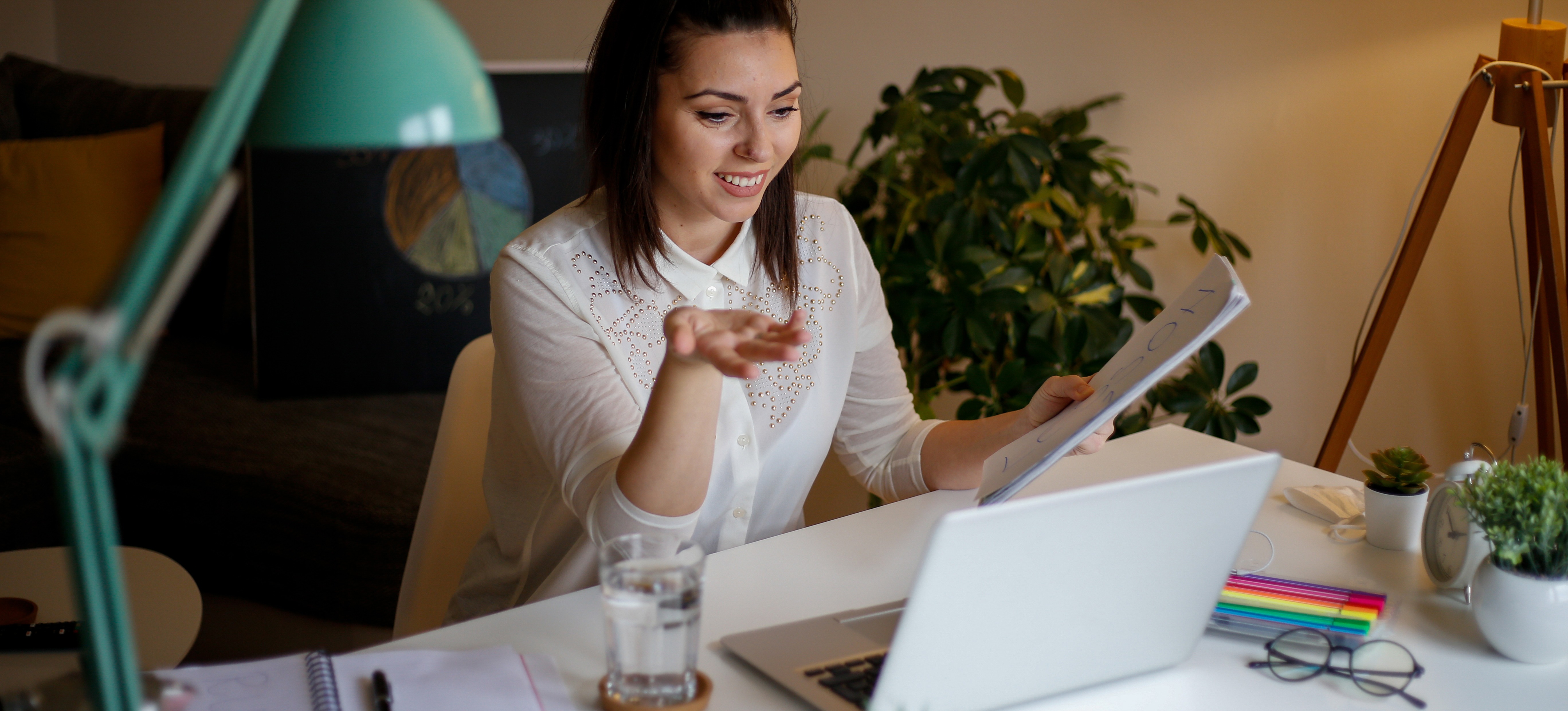 [Featured image] A professional in a white blouse sits in front of their laptop during a Zoom interview.