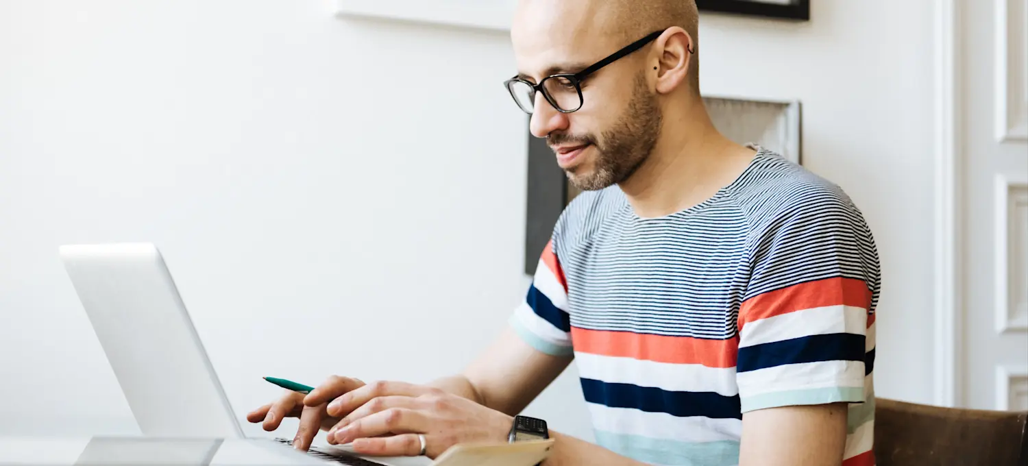 [Featured Image]  A person at their laptop is setting up open bidding in the Google Ads Manager.