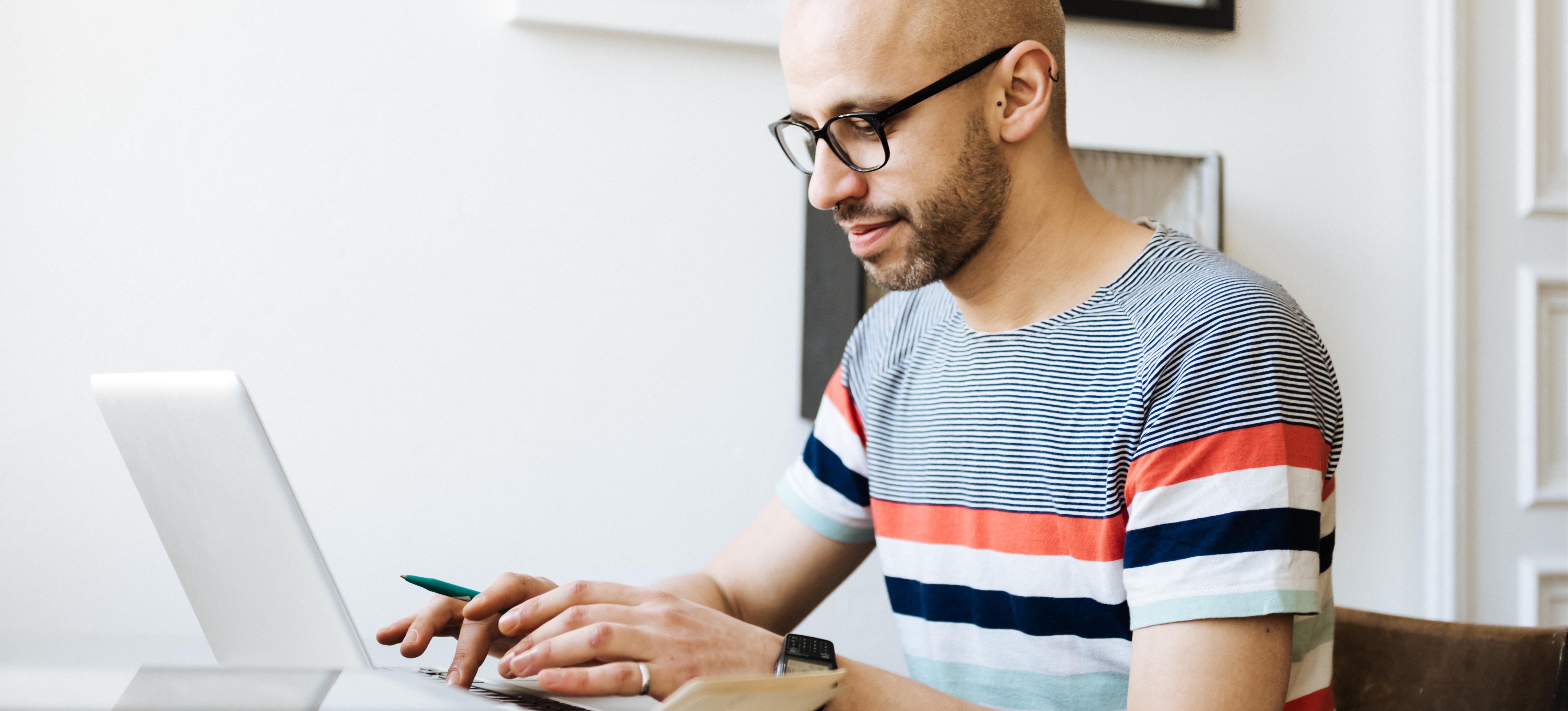 [Featured Image]  A man at his laptop is setting up open bidding in the Google Ads Manager.