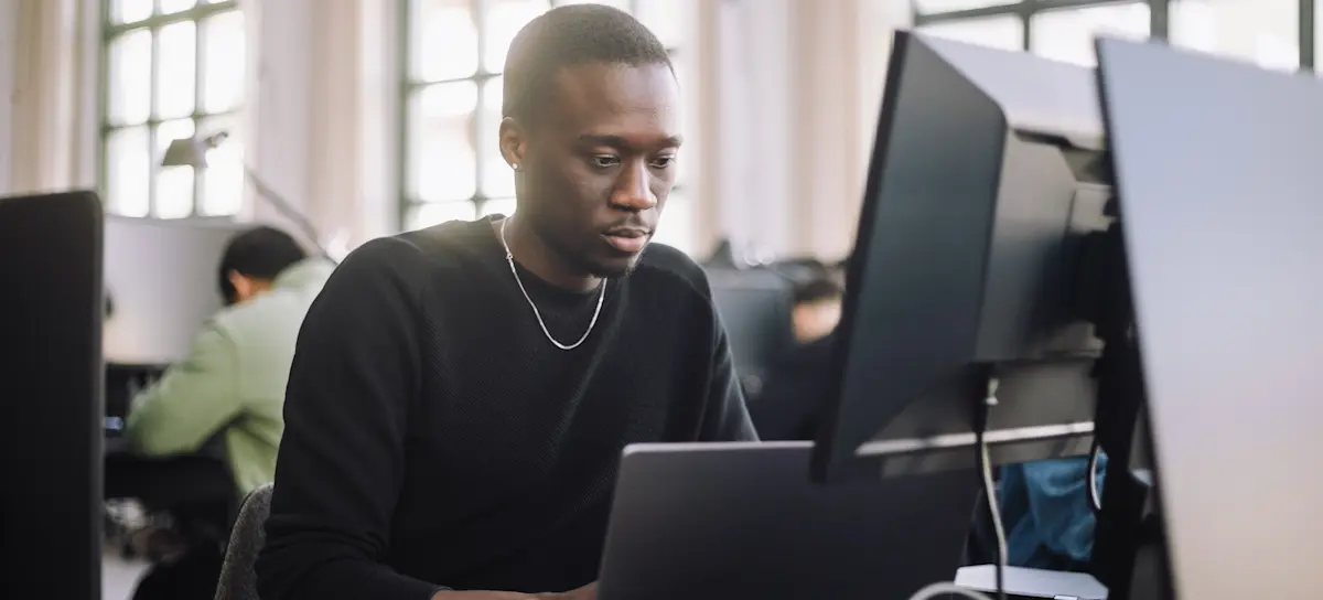 [Featured Image] Male businessman working in artificial intelligence uses work computer to study the sigmoid activation function