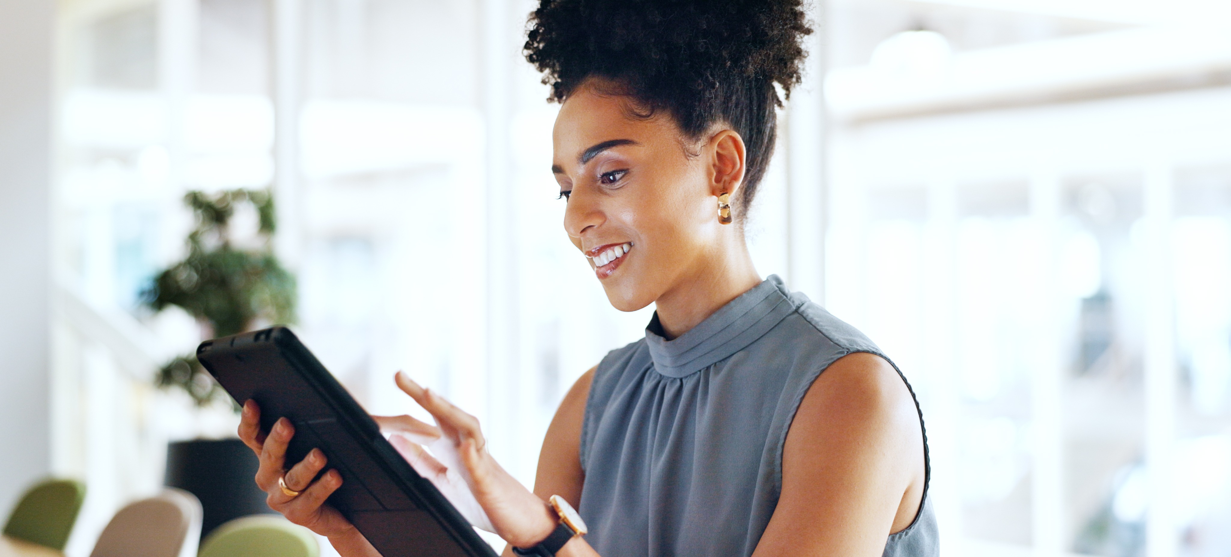 [Featured Image] A young marketing professional studies for their Google Ads certification on a tablet. 

